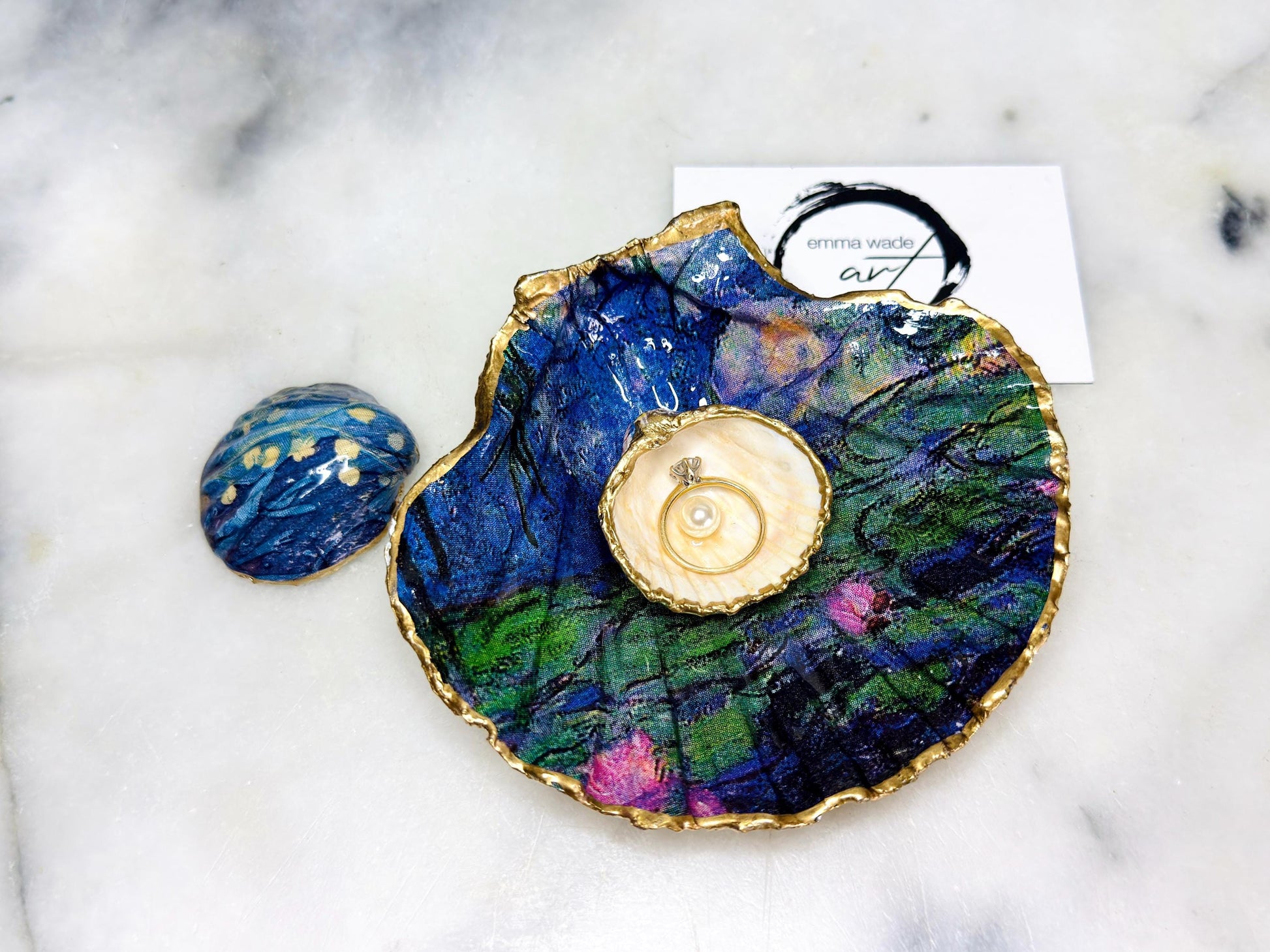 Claude Monet Waterlilies inspired shell dish set featuring a scallop trinket dish and cockle ring holder | Decorated with blue and pink floral waterlilies | Gilded with real gold leaf and sealed in high gloss resin | Perfect as a wedding ring tray, jewellery dish, or vanity display | Handmade in Dorset from sustainably sourced shells | A coastal art-inspired gift for weddings, birthdays, or anniversaries
