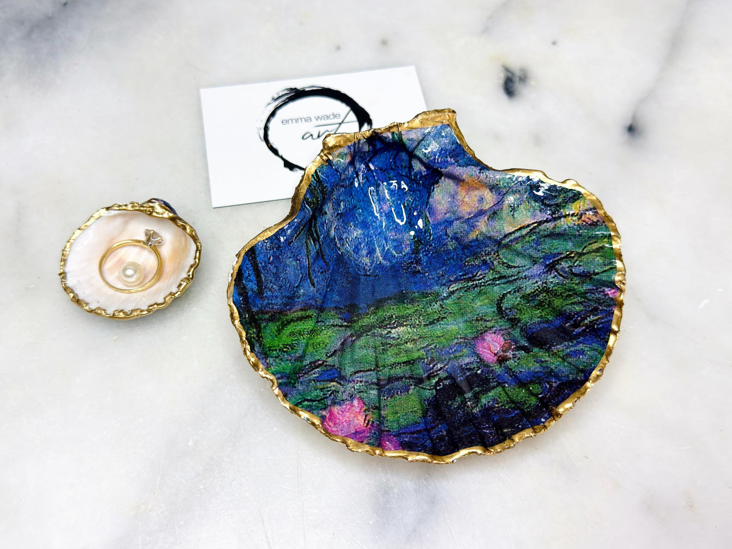 Claude Monet Waterlilies inspired shell dish set featuring a scallop trinket dish and cockle ring holder | Decorated with blue and pink floral waterlilies | Gilded with real gold leaf and sealed in high gloss resin | Perfect as a wedding ring tray, jewellery dish, or vanity display | Handmade in Dorset from sustainably sourced shells | A coastal art-inspired gift for weddings, birthdays, or anniversaries