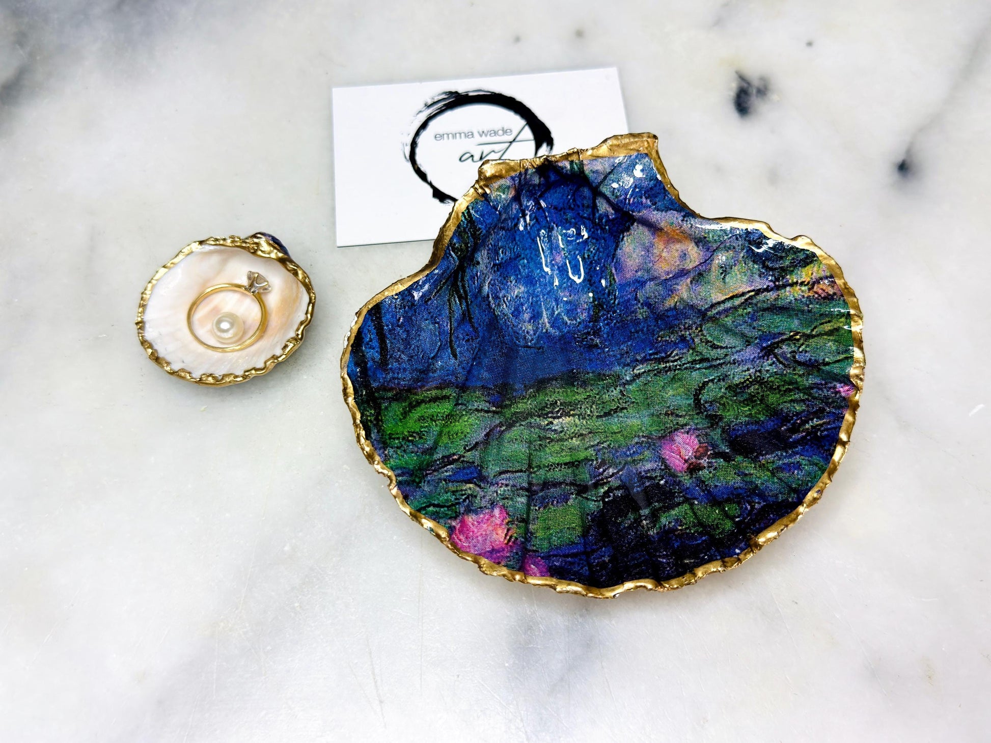 Claude Monet Waterlilies inspired shell dish set featuring a scallop trinket dish and cockle ring holder | Decorated with blue and pink floral waterlilies | Gilded with real gold leaf and sealed in high gloss resin | Perfect as a wedding ring tray, jewellery dish, or vanity display | Handmade in Dorset from sustainably sourced shells | A coastal art-inspired gift for weddings, birthdays, or anniversaries