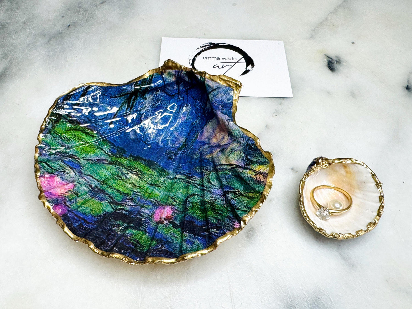 Claude Monet Waterlilies inspired shell dish set featuring a scallop trinket dish and cockle ring holder | Decorated with blue and pink floral waterlilies | Gilded with real gold leaf and sealed in high gloss resin | Perfect as a wedding ring tray, jewellery dish, or vanity display | Handmade in Dorset from sustainably sourced shells | A coastal art-inspired gift for weddings, birthdays, or anniversaries