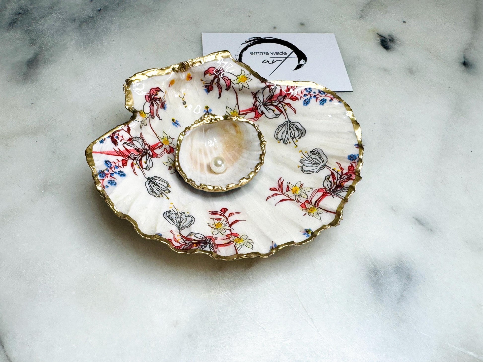 Handcrafted Dorset shell dish set featuring red and blue floral designs on scallop and cockle shells | Cockle shell includes a Swarovski pearl ring rest to prevent rings from sliding | Gilded with liquid gold leaf and sealed with glossy resin | Perfect as a jewellery or ring holder, trinket tray, or coastal gift | Each shell is sustainably sourced and hand finished in the UK | Ideal wedding or anniversary keepsake