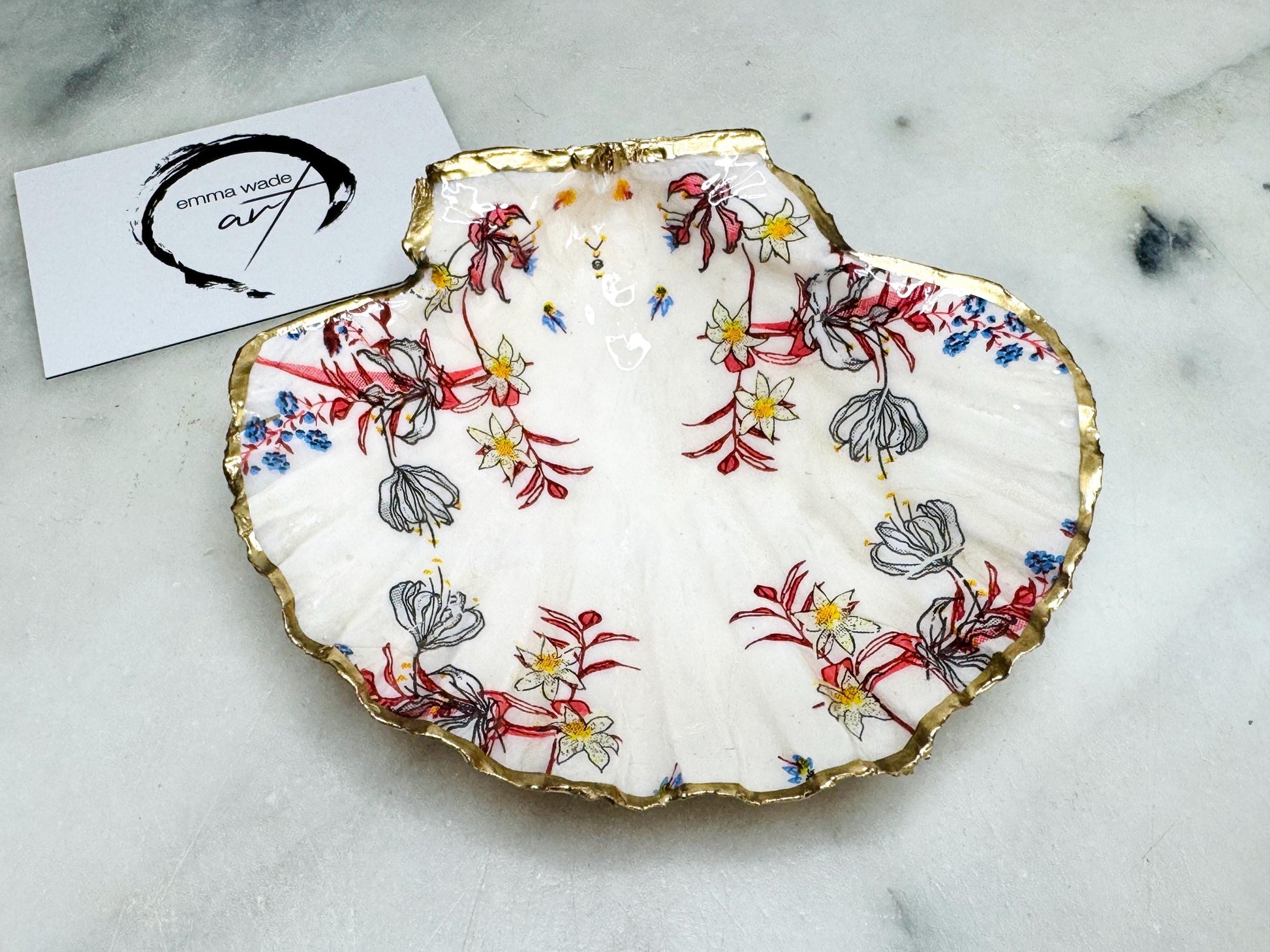 Handcrafted Dorset shell dish set featuring red and blue floral designs on scallop and cockle shells | Cockle shell includes a Swarovski pearl ring rest to prevent rings from sliding | Gilded with liquid gold leaf and sealed with glossy resin | Perfect as a jewellery or ring holder, trinket tray, or coastal gift | Each shell is sustainably sourced and hand finished in the UK | Ideal wedding or anniversary keepsake