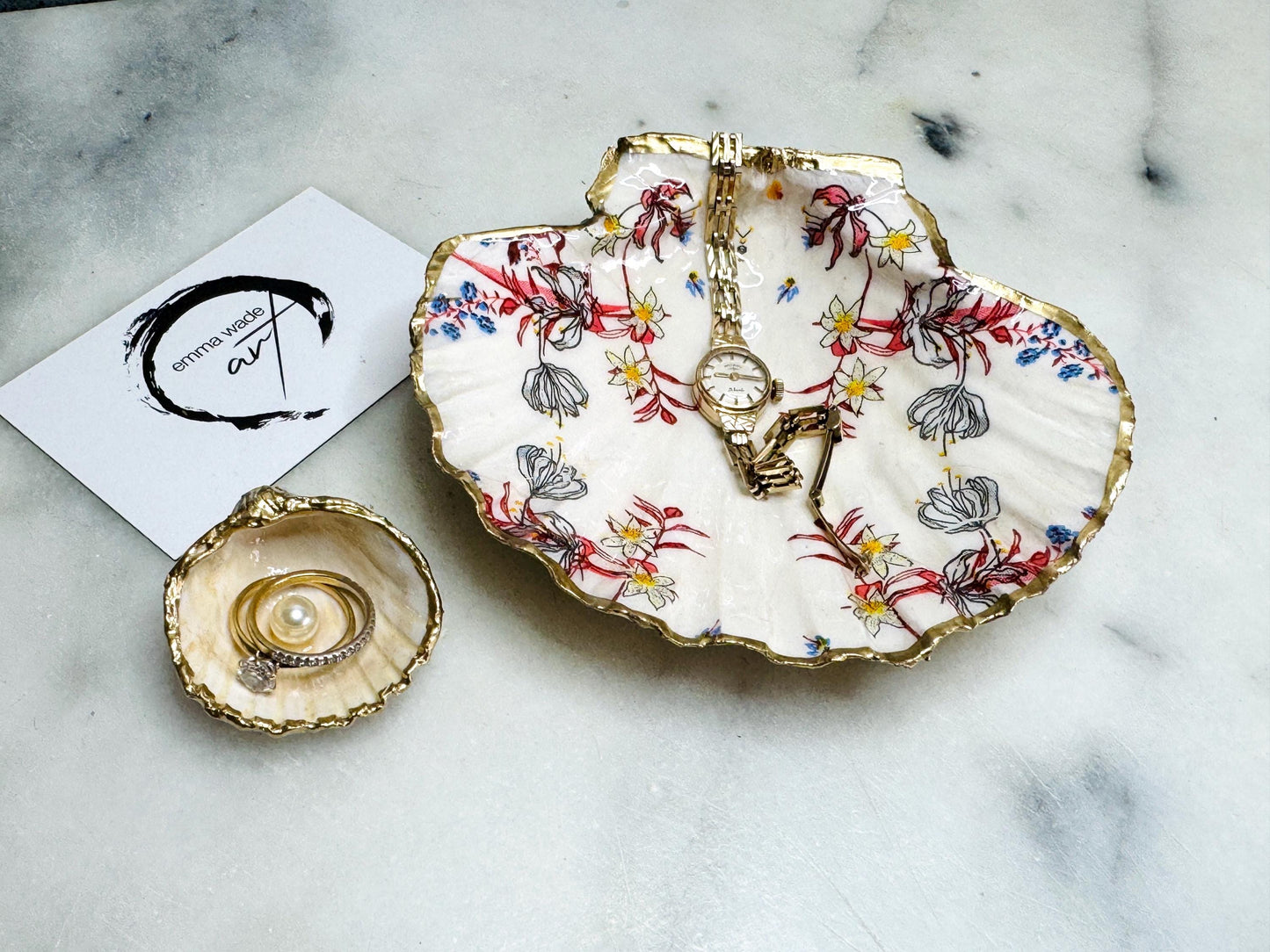 Handcrafted Dorset shell dish set featuring red and blue floral designs on scallop and cockle shells | Cockle shell includes a Swarovski pearl ring rest to prevent rings from sliding | Gilded with liquid gold leaf and sealed with glossy resin | Perfect as a jewellery or ring holder, trinket tray, or coastal gift | Each shell is sustainably sourced and hand finished in the UK | Ideal wedding or anniversary keepsake