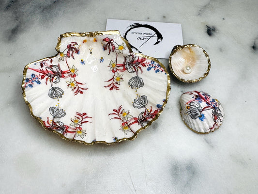 Handcrafted Dorset shell dish set featuring red and blue floral designs on scallop and cockle shells | Cockle shell includes a Swarovski pearl ring rest to prevent rings from sliding | Gilded with liquid gold leaf and sealed with glossy resin | Perfect as a jewellery or ring holder, trinket tray, or coastal gift | Each shell is sustainably sourced and hand finished in the UK | Ideal wedding or anniversary keepsake