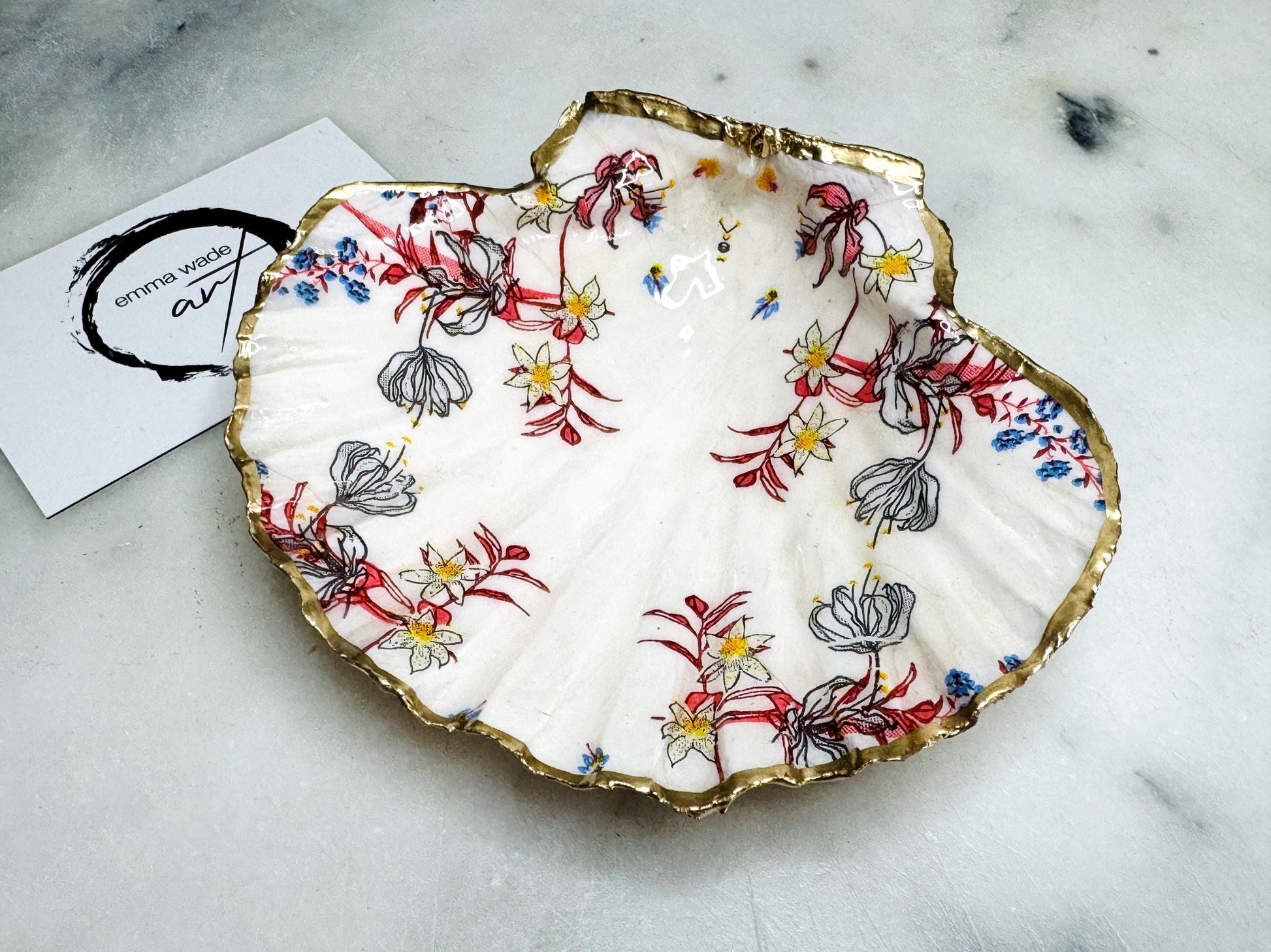 Handcrafted Dorset shell dish set featuring red and blue floral designs on scallop and cockle shells | Cockle shell includes a Swarovski pearl ring rest to prevent rings from sliding | Gilded with liquid gold leaf and sealed with glossy resin | Perfect as a jewellery or ring holder, trinket tray, or coastal gift | Each shell is sustainably sourced and hand finished in the UK | Ideal wedding or anniversary keepsake