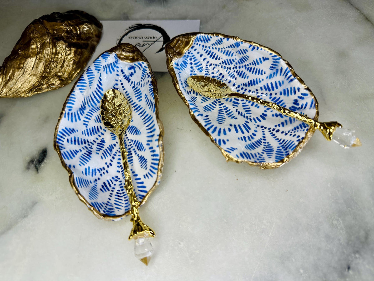 Sustainable Dorset oyster shell cruet set featuring blue floral designs and real gold leaf edges | Handmade salt and pepper pinch pots, sealed with food-safe glossy resin and presented in a sustainable kraft gift box | A unique salt gift for weddings, anniversaries, and coastal dining | Includes optional gold crystal spoons | Perfect handmade gift for beach house decor or ocean-inspired table styling | Maimekko Design