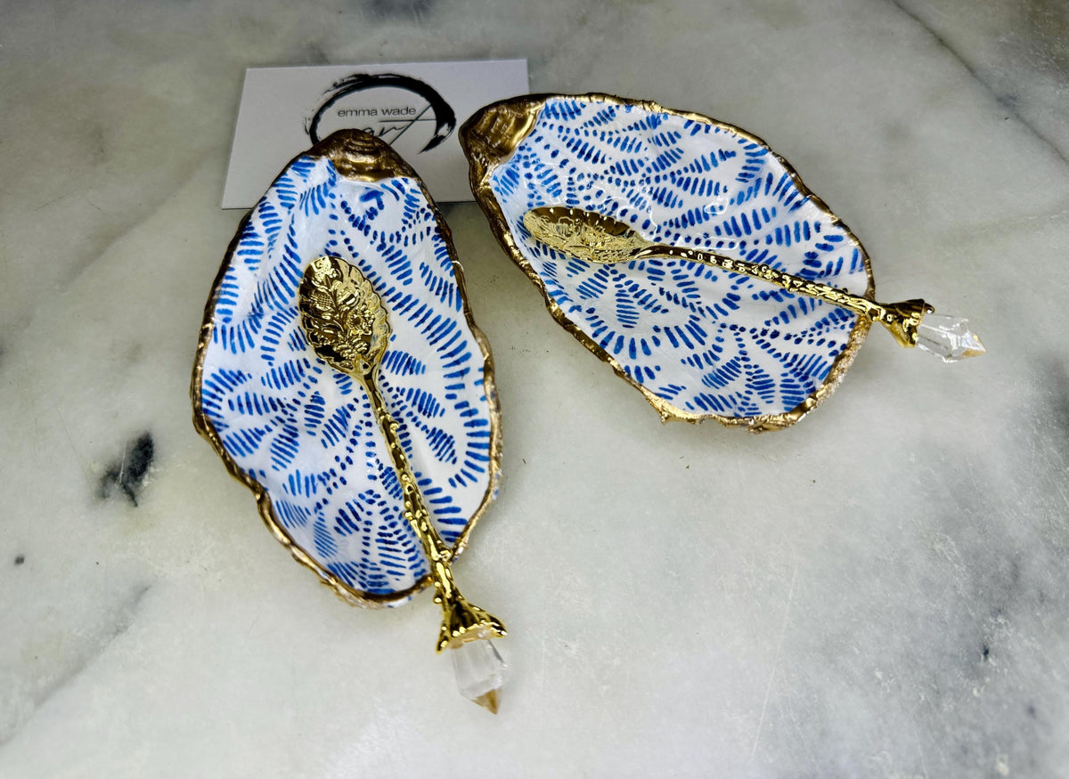 Sustainable Dorset oyster shell cruet set featuring blue floral designs and real gold leaf edges | Handmade salt and pepper pinch pots, sealed with food-safe glossy resin and presented in a sustainable kraft gift box | A unique salt gift for weddings, anniversaries, and coastal dining | Includes optional gold crystal spoons | Perfect handmade gift for beach house decor or ocean-inspired table styling | Maimekko Design