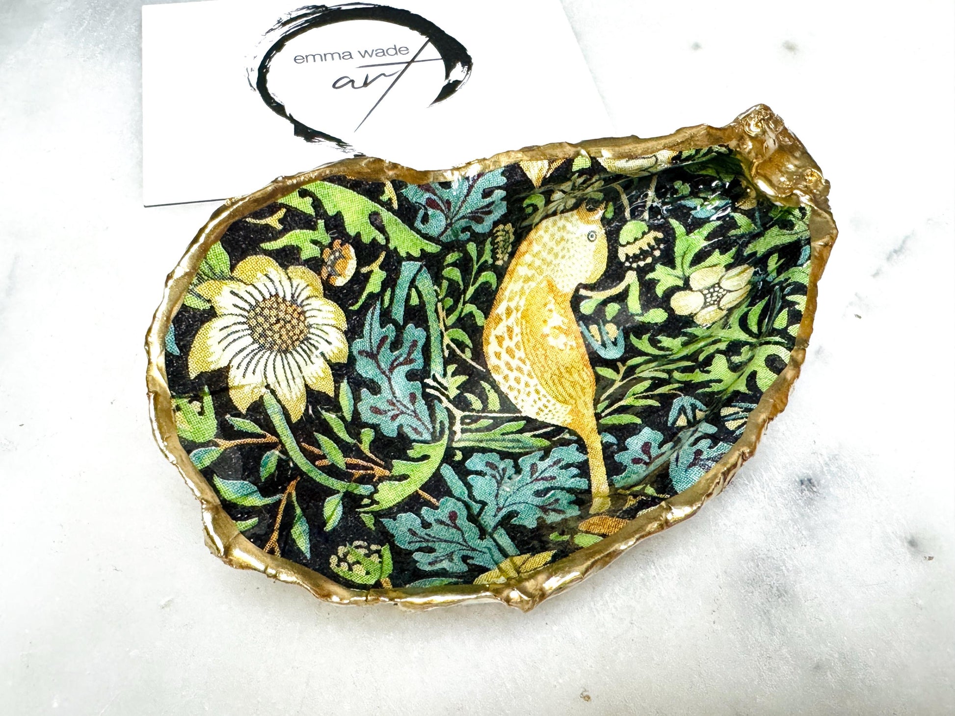 Handcrafted William Morris Strawberry Thief oyster shell dish. Gilded with real gold leaf and finished with glossy resin. Two designs available. Ideal as a jewellery dish, trinket holder, cufflink or tie pin dish, tea light holder, or salt and pepper pinch pot. Sustainable coastal décor, UK handmade shell ornament, unique gift for weddings, birthdays, anniversaries, or Christmas.