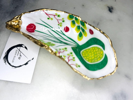 Handmade Dorset oyster shell trinket dish featuring colourful garden fruit artwork in green, yellow, and red tones with hand-gilded gold leaf edging and glossy resin finish. Coastal jewellery holder and botanical home décor gift.