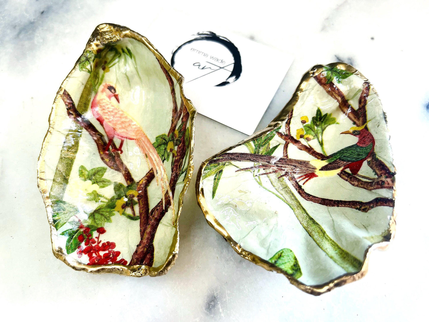 Handmade oyster shell jewellery catcher dish with Birds of Paradise design in red or pink. Each Dorset shell is finished with gold leaf edging and glossy resin, making it unique and one of a kind. Use as an oyster ring dish, jewellery tray, or trinket dish for rings, earrings, cufflinks, or keepsakes. A beautiful shell jewellery organiser and coastal-inspired ornament. Perfect handmade bird lover gift for weddings, anniversaries, birthdays, bridesmaids, or Christmas.