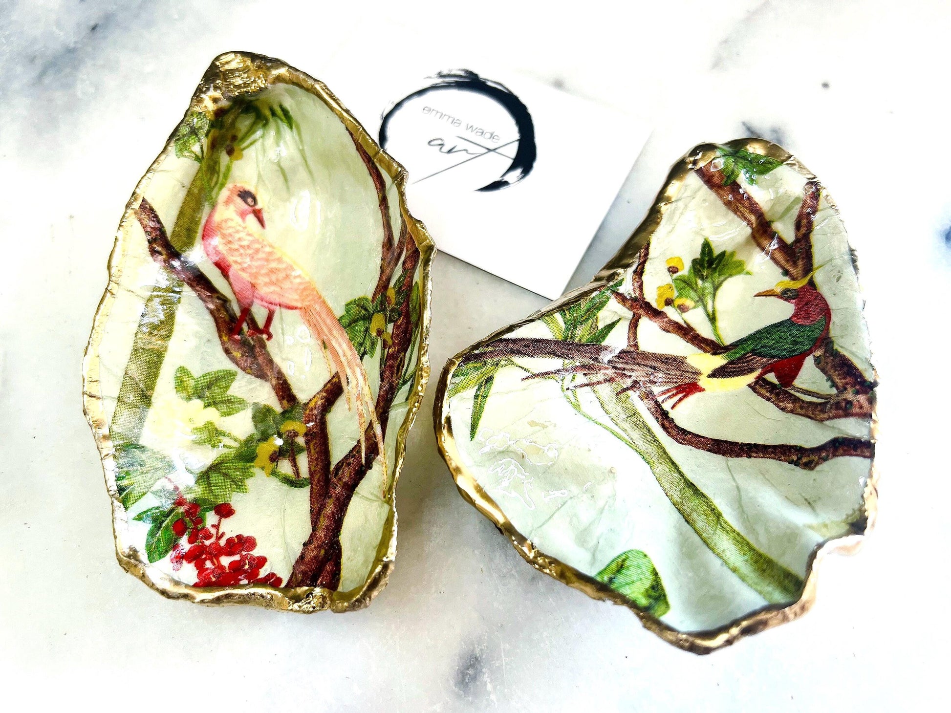 Handmade oyster shell jewellery catcher dish with Birds of Paradise design in red or pink. Each Dorset shell is finished with gold leaf edging and glossy resin, making it unique and one of a kind. Use as an oyster ring dish, jewellery tray, or trinket dish for rings, earrings, cufflinks, or keepsakes. A beautiful shell jewellery organiser and coastal-inspired ornament. Perfect handmade bird lover gift for weddings, anniversaries, birthdays, bridesmaids, or Christmas.