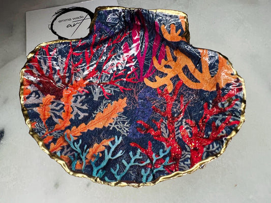 Handmade Dorset scallop shell trinket dish featuring vibrant coral reef and seaweed design in red orange turquoise and navy blue tones, finished with hand gilded gold leaf edging and glossy resin, luxury coastal jewellery holder and ocean inspired decor
