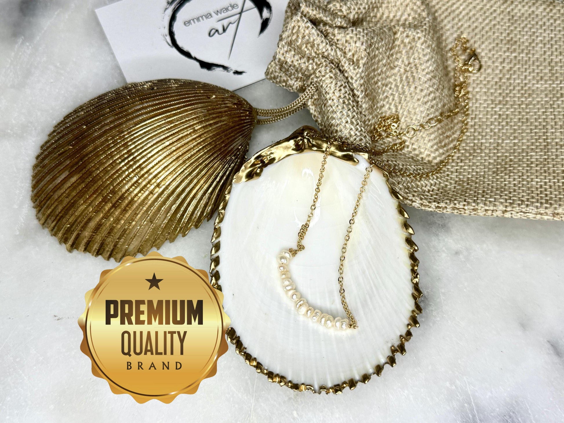 Handmade gold gilded cockle shell jewellery box with pearly white interior and optional freshwater pearl necklace. Coastal shell ring box crafted from natural Dorset shells, edged with liquid gold leaf and presented in a luxury gift box. Elegant seaside-inspired keepsake gift for weddings, bridesmaids, birthdays, anniversaries, or jewellery storage.