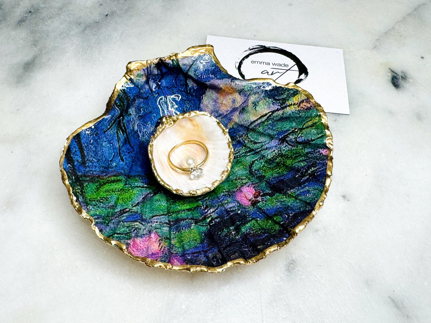 Claude Monet Waterlilies inspired shell dish set featuring a scallop trinket dish and cockle ring holder | Decorated with blue and pink floral waterlilies | Gilded with real gold leaf and sealed in high gloss resin | Perfect as a wedding ring tray, jewellery dish, or vanity display | Handmade in Dorset from sustainably sourced shells | A coastal art-inspired gift for weddings, birthdays, or anniversaries