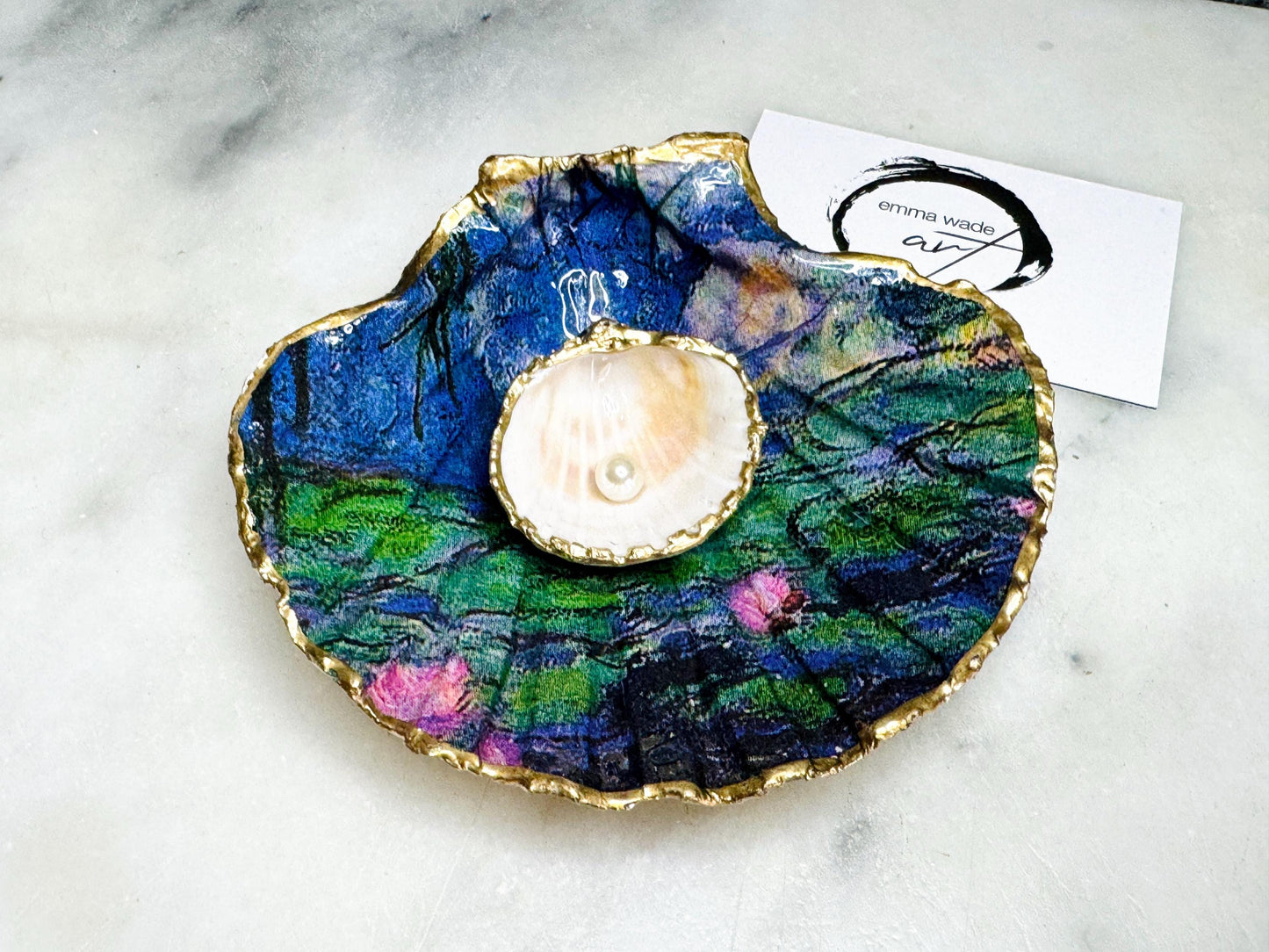 Claude Monet Waterlilies inspired shell dish set featuring a scallop trinket dish and cockle ring holder | Decorated with blue and pink floral waterlilies | Gilded with real gold leaf and sealed in high gloss resin | Perfect as a wedding ring tray, jewellery dish, or vanity display | Handmade in Dorset from sustainably sourced shells | A coastal art-inspired gift for weddings, birthdays, or anniversaries