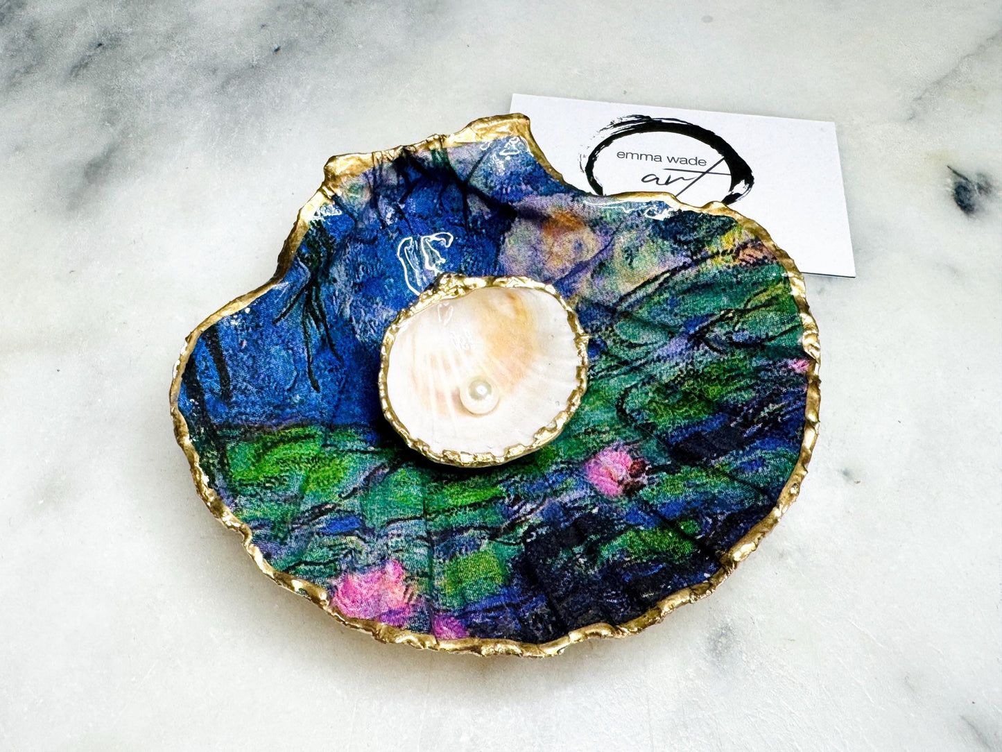 Claude Monet Waterlilies inspired shell dish set featuring a scallop trinket dish and cockle ring holder | Decorated with blue and pink floral waterlilies | Gilded with real gold leaf and sealed in high gloss resin | Perfect as a wedding ring tray, jewellery dish, or vanity display | Handmade in Dorset from sustainably sourced shells | A coastal art-inspired gift for weddings, birthdays, or anniversaries