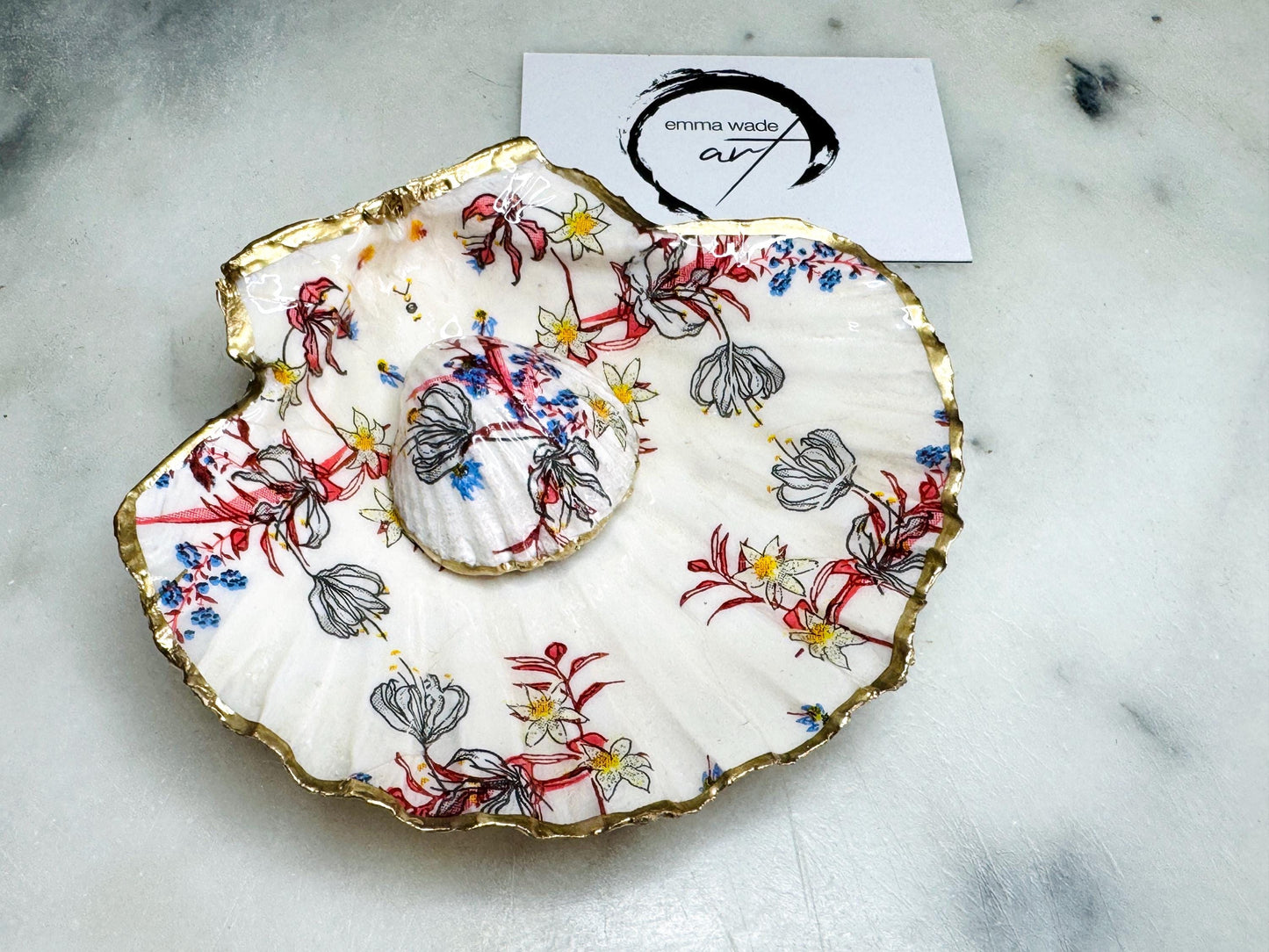 Handcrafted Dorset shell dish set featuring red and blue floral designs on scallop and cockle shells | Cockle shell includes a Swarovski pearl ring rest to prevent rings from sliding | Gilded with liquid gold leaf and sealed with glossy resin | Perfect as a jewellery or ring holder, trinket tray, or coastal gift | Each shell is sustainably sourced and hand finished in the UK | Ideal wedding or anniversary keepsake