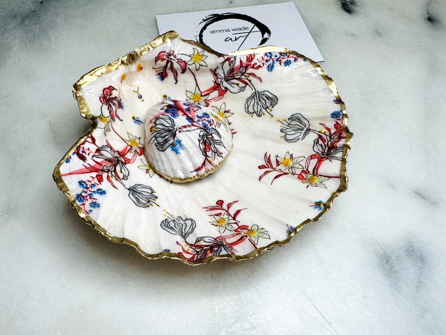 Handcrafted Dorset shell dish set featuring red and blue floral designs on scallop and cockle shells | Cockle shell includes a Swarovski pearl ring rest to prevent rings from sliding | Gilded with liquid gold leaf and sealed with glossy resin | Perfect as a jewellery or ring holder, trinket tray, or coastal gift | Each shell is sustainably sourced and hand finished in the UK | Ideal wedding or anniversary keepsake