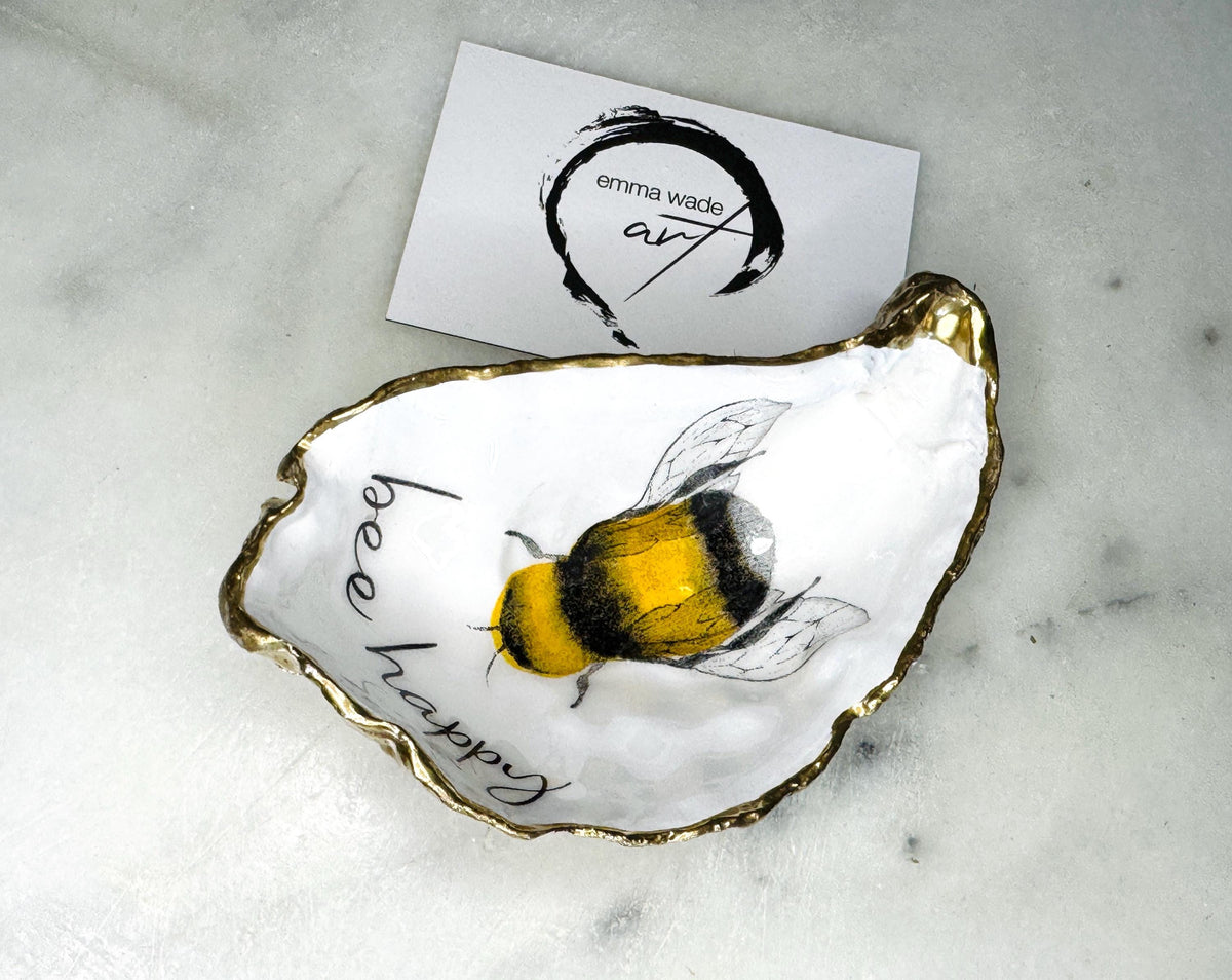 bee happy oyster shell trinket dish, Dorset oyster shell jewellery holder, handmade bee design coastal decor, gold leaf gilded oyster shell ornament, sustainable oyster shell dish UK, bumble bee oyster shell jewellery tray, nature inspired bee oyster shell gift, eco friendly oyster shell bathroom accessory, oyster shell salt and pepper pinch pot, unique bee themed oyster shell keepsake, handmade Dorset oyster shell decor, bee lover jewellery dish gift, coastal oyster shell art UK