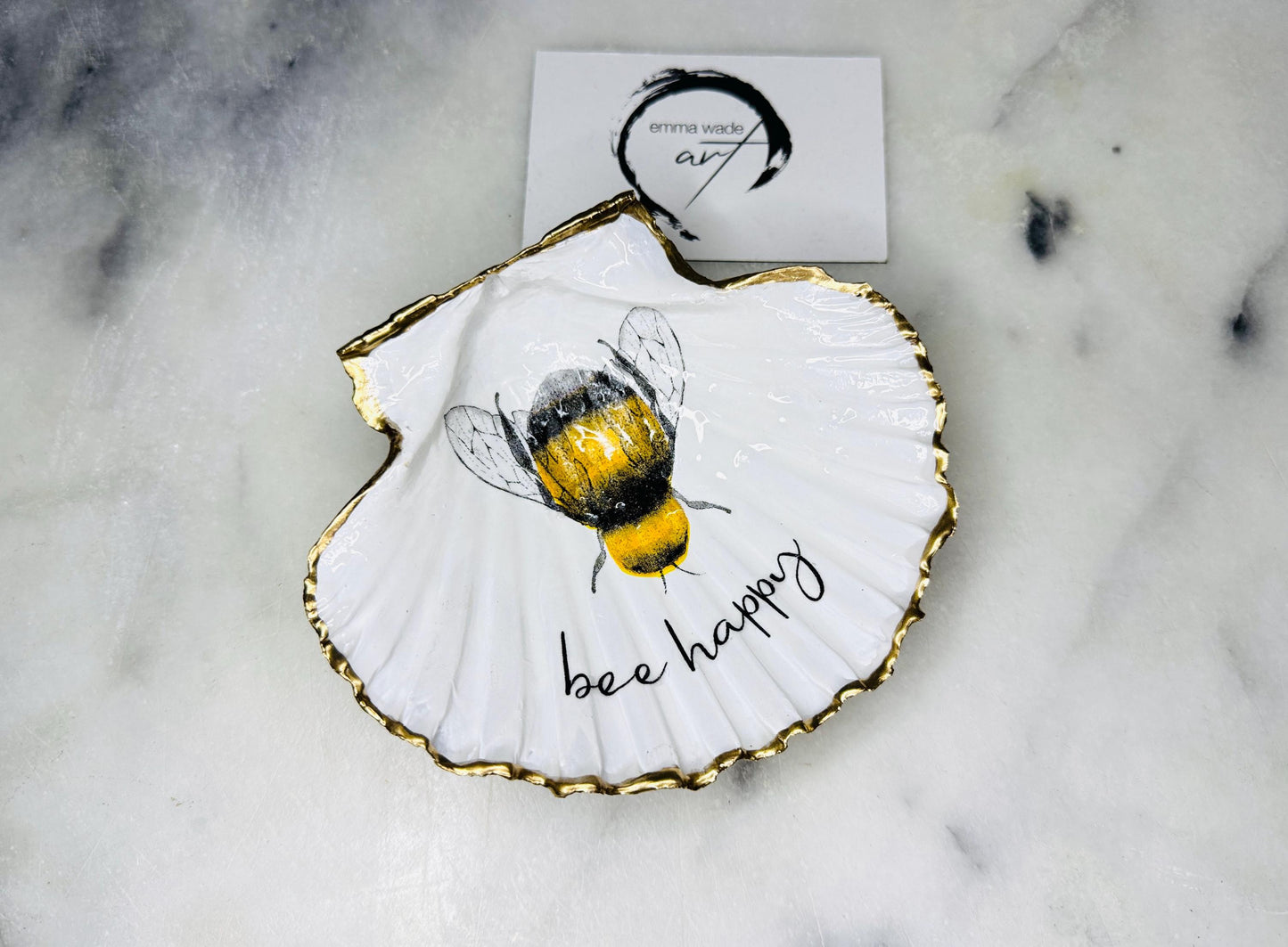 bee happy scallop shell trinket dish, Dorset scallop shell jewellery holder, handmade bee design coastal decor, gold leaf gilded scallop shell ornament, sustainable scallop shell dish UK, bumble bee scallop shell jewellery tray, nature inspired bee scallop shell gift, eco friendly oyster shell bathroom accessory, scallop shell salt and pepper pinch pot, unique bee themed shell keepsake, handmade Dorset shell decor, bee lover jewellery dish gift, coastal oyster shell art UK