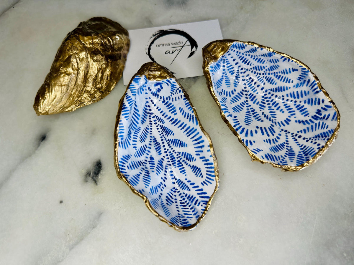 Sustainable Dorset oyster shell cruet set featuring blue floral designs and real gold leaf edges | Handmade salt and pepper pinch pots, sealed with food-safe glossy resin and presented in a sustainable kraft gift box | A unique salt gift for weddings, anniversaries, and coastal dining | Includes optional gold crystal spoons | Perfect handmade gift for beach house decor or ocean-inspired table styling | Maimekko Design