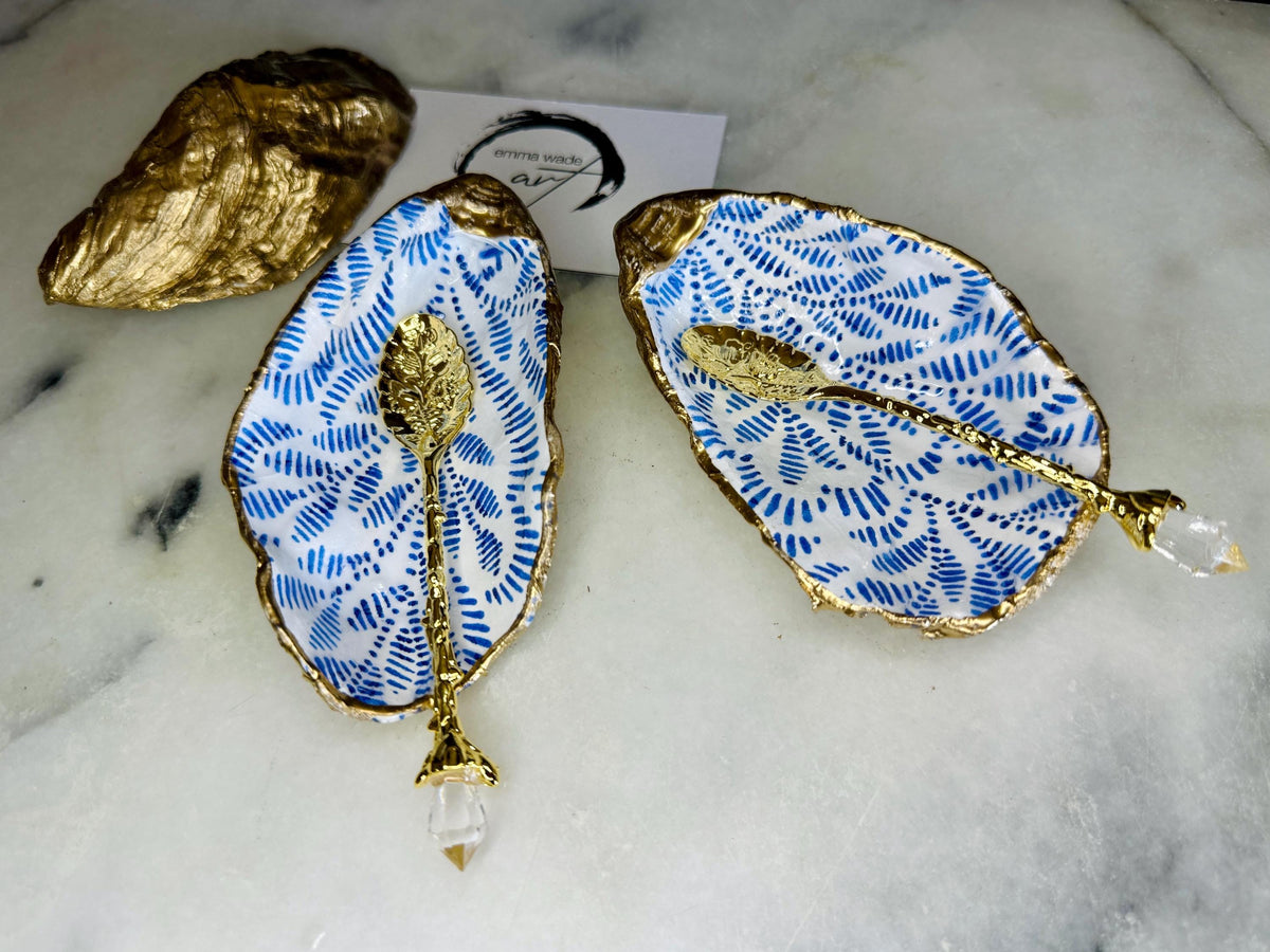 Sustainable Dorset oyster shell cruet set featuring blue floral designs and real gold leaf edges | Handmade salt and pepper pinch pots, sealed with food-safe glossy resin and presented in a sustainable kraft gift box | A unique salt gift for weddings, anniversaries, and coastal dining | Includes optional gold crystal spoons | Perfect handmade gift for beach house decor or ocean-inspired table styling | Maimekko Design