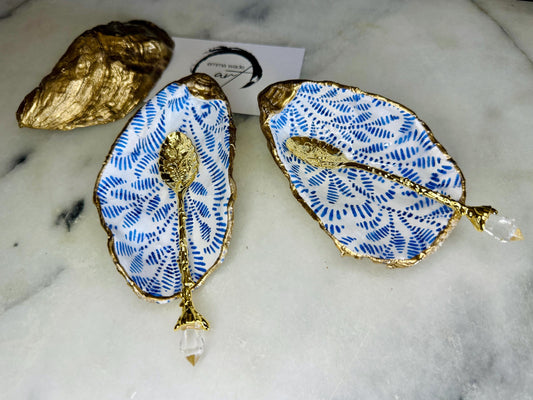 Sustainable Dorset oyster shell cruet set featuring blue floral designs and real gold leaf edges | Handmade salt and pepper pinch pots, sealed with food-safe glossy resin and presented in a sustainable kraft gift box | A unique salt gift for weddings, anniversaries, and coastal dining | Includes optional gold crystal spoons | Perfect handmade gift for beach house decor or ocean-inspired table styling | Maimekko Design