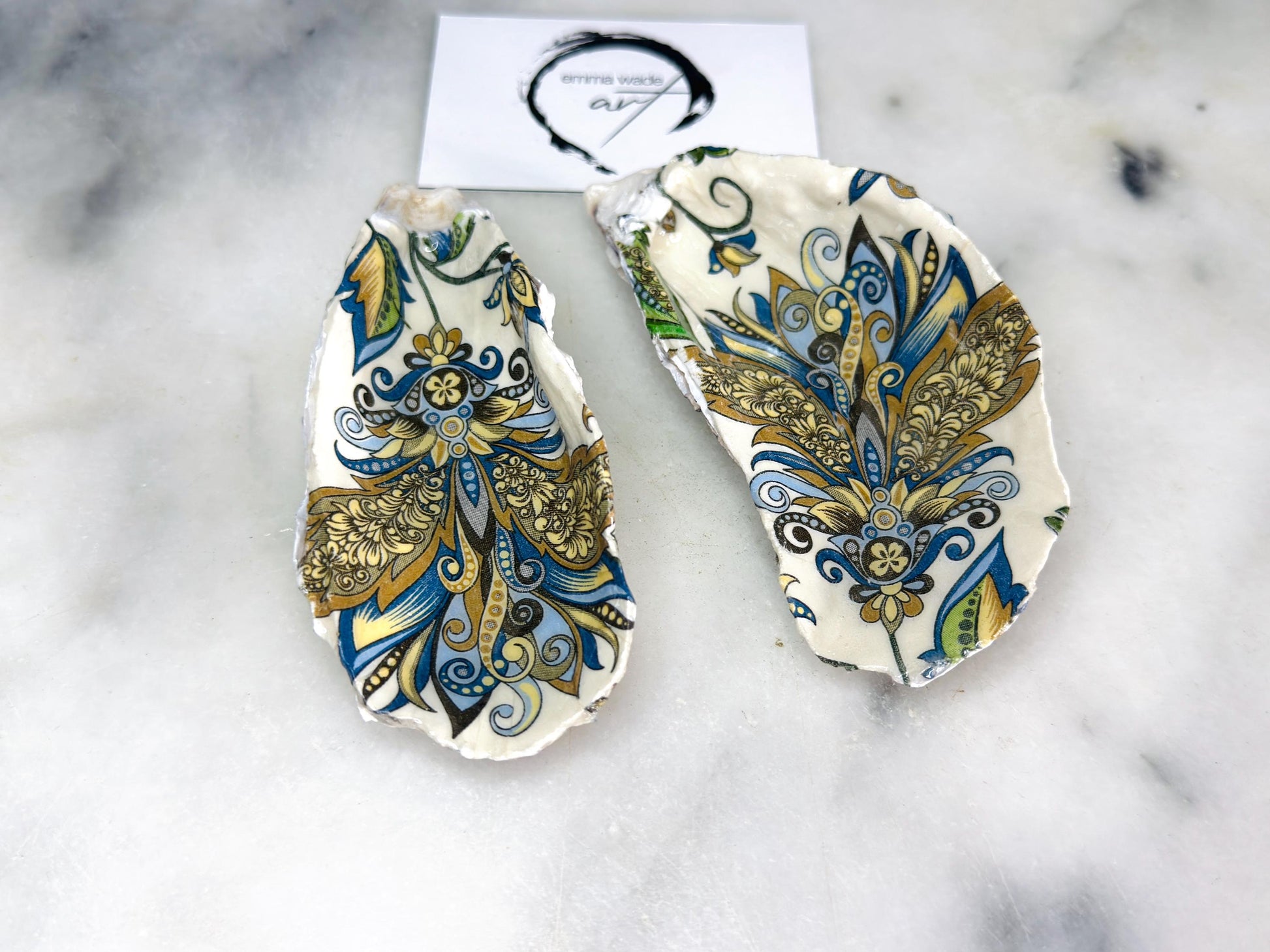 Pair of decorative oyster shell salt and pepper dishes styled as elegant table accessories, featuring hand painted baroque gold detailing and natural shell shapes, perfect as a coastal home decor or dinner party gift.
