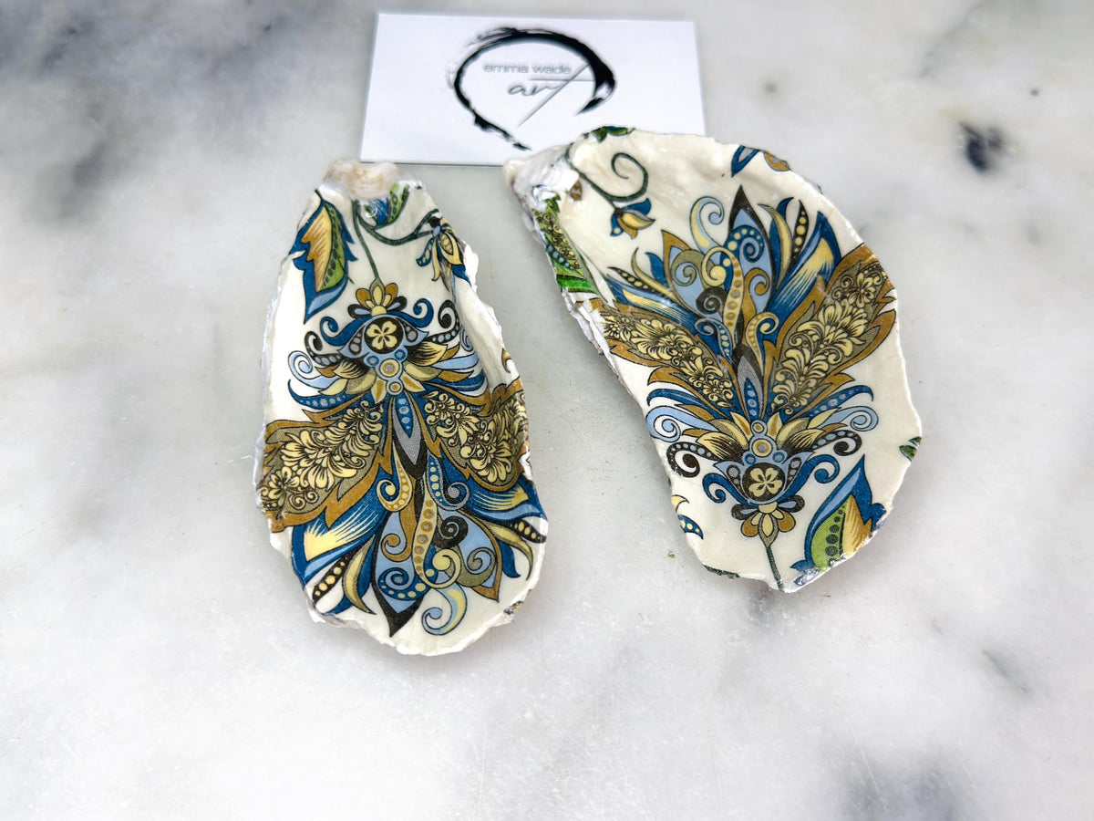 Pair of decorative oyster shell salt and pepper dishes styled as elegant table accessories, featuring hand painted baroque gold detailing and natural shell shapes, perfect as a coastal home decor or dinner party gift.