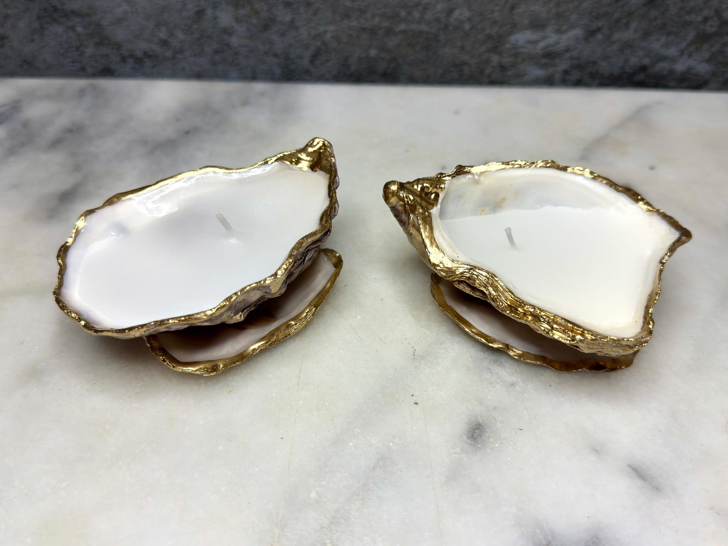oyster shell candle, gold oyster candle, gilded oyster shells, hand poured candle, coastal decor, ocean inspired candle, beach home decor, sustainable candle, handmade in Surrey, luxury shell candle, sea lover gift, oyster shell pair, artisan candle, eco friendly candle, gold rim shell, nautical decor, ocean gift, coastal homeware, handmade oyster shell candle, shell wedding decor, seaside candle, mother of pearl shell, gold edged candle, beach cottage style, elegant coastal gift