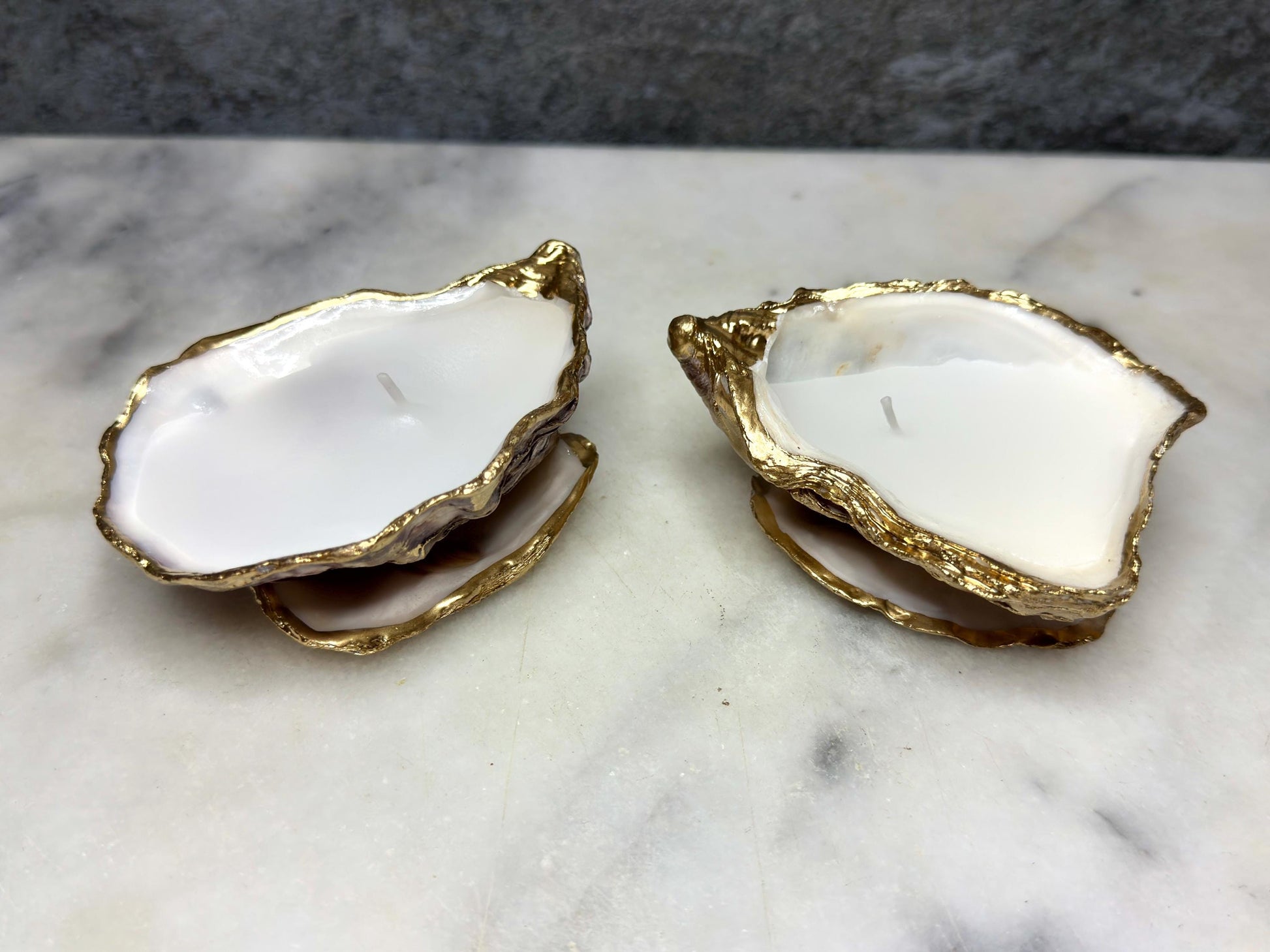 oyster shell candle, gold oyster candle, gilded oyster shells, hand poured candle, coastal decor, ocean inspired candle, beach home decor, sustainable candle, handmade in Surrey, luxury shell candle, sea lover gift, oyster shell pair, artisan candle, eco friendly candle, gold rim shell, nautical decor, ocean gift, coastal homeware, handmade oyster shell candle, shell wedding decor, seaside candle, mother of pearl shell, gold edged candle, beach cottage style, elegant coastal gift