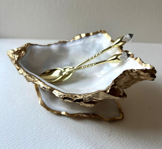 Extra large Dorset oyster shell serving dish set with natural pearl interior and hand-applied gold leaf edging, featuring a cupped XL oyster shell with matching flat shell base. Luxury coastal home décor ideal as a sugar dish, serving bowl, coffee station accessory, or elegant host gift. Handmade using sustainably sourced UK oyster shells and finished with glossy resin and optional gold serving accessories.