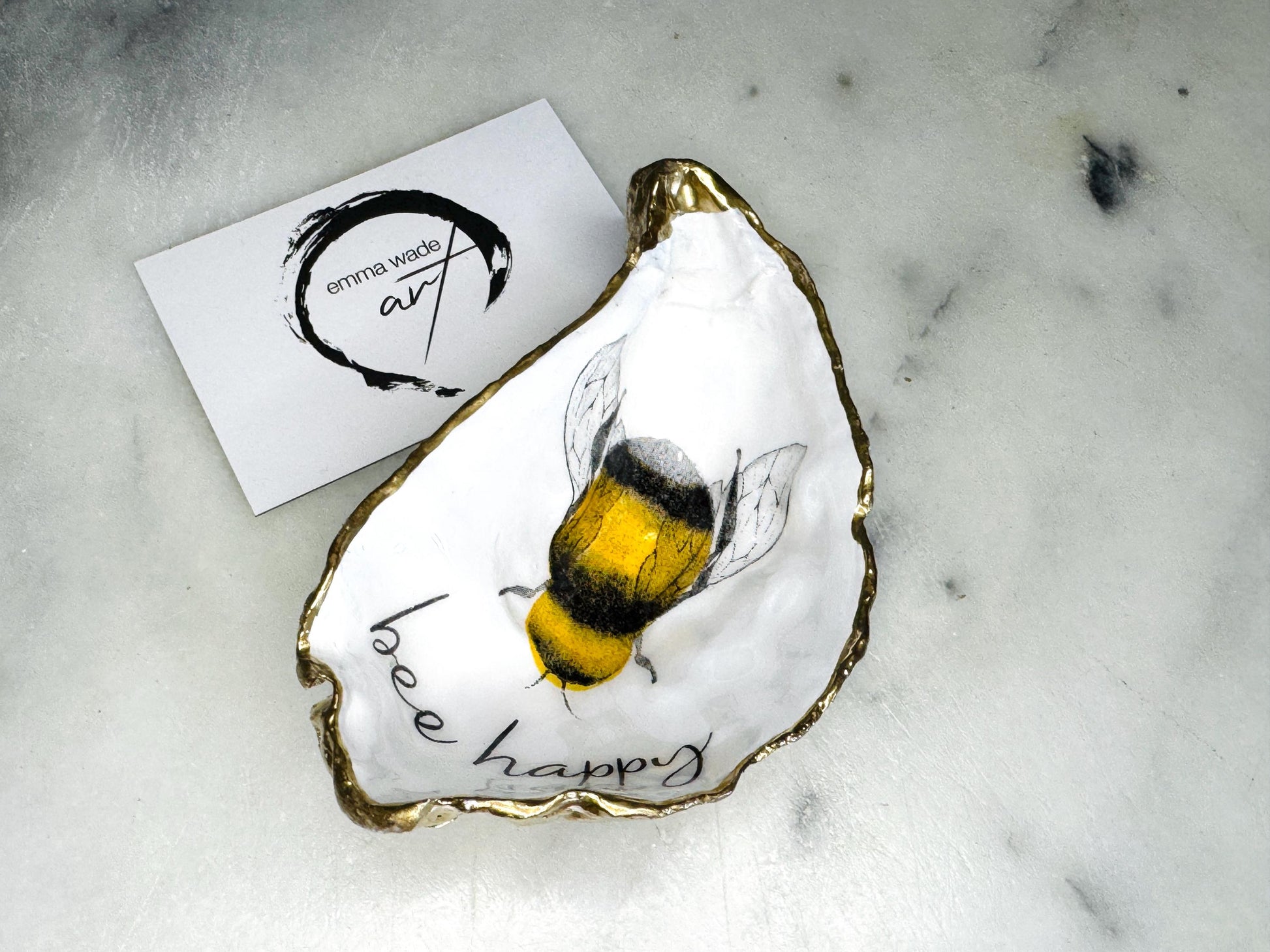 bee happy oyster shell trinket dish, Dorset oyster shell jewellery holder, handmade bee design coastal decor, gold leaf gilded oyster shell ornament, sustainable oyster shell dish UK, bumble bee oyster shell jewellery tray, nature inspired bee oyster shell gift, eco friendly oyster shell bathroom accessory, oyster shell salt and pepper pinch pot, unique bee themed oyster shell keepsake, handmade Dorset oyster shell decor, bee lover jewellery dish gift, coastal oyster shell art UK