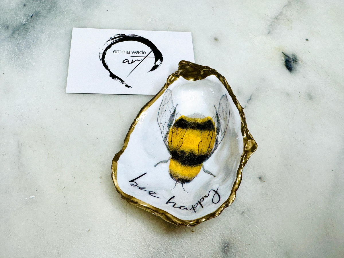 bee happy oyster shell trinket dish, Dorset oyster shell jewellery holder, handmade bee design coastal decor, gold leaf gilded oyster shell ornament, sustainable oyster shell dish UK, bumble bee oyster shell jewellery tray, nature inspired bee oyster shell gift, eco friendly oyster shell bathroom accessory, oyster shell salt and pepper pinch pot, unique bee themed oyster shell keepsake, handmade Dorset oyster shell decor, bee lover jewellery dish gift, coastal oyster shell art UK