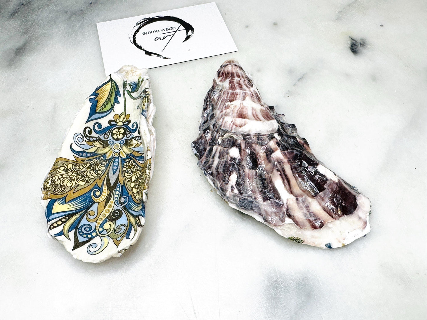 Close up of a handmade oyster shell salt dish showing the baroque gold decoration and natural shell texture, sealed with a glossy finish and crafted as luxury coastal tableware from Dorset shells.