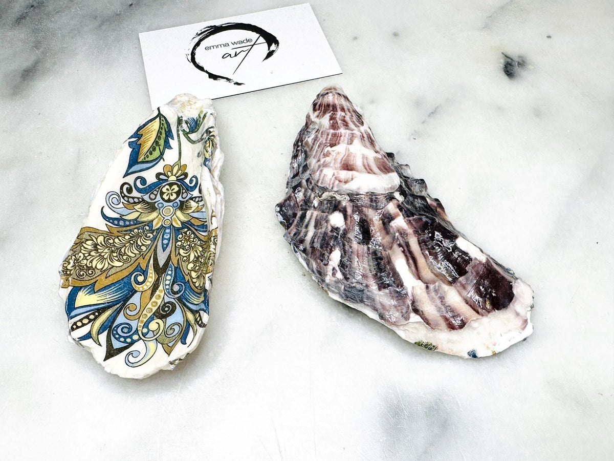 Close up of a handmade oyster shell salt dish showing the baroque gold decoration and natural shell texture, sealed with a glossy finish and crafted as luxury coastal tableware from Dorset shells.