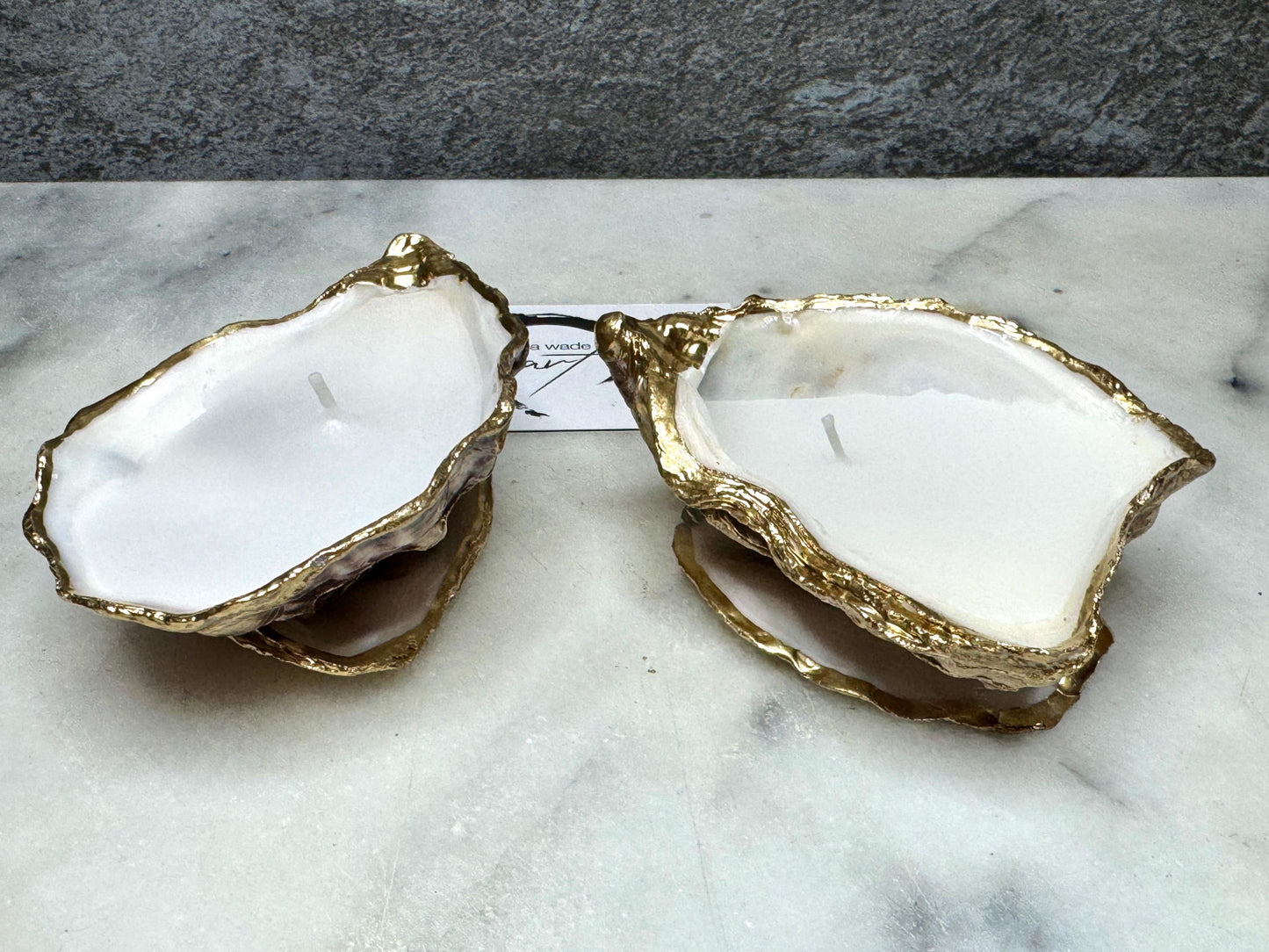 oyster shell candle, gold oyster candle, gilded oyster shells, hand poured candle, coastal decor, ocean inspired candle, beach home decor, sustainable candle, handmade in Surrey, luxury shell candle, sea lover gift, oyster shell pair, artisan candle, eco friendly candle, gold rim shell, nautical decor, ocean gift, coastal homeware, handmade oyster shell candle, shell wedding decor, seaside candle, mother of pearl shell, gold edged candle, beach cottage style, elegant coastal gift