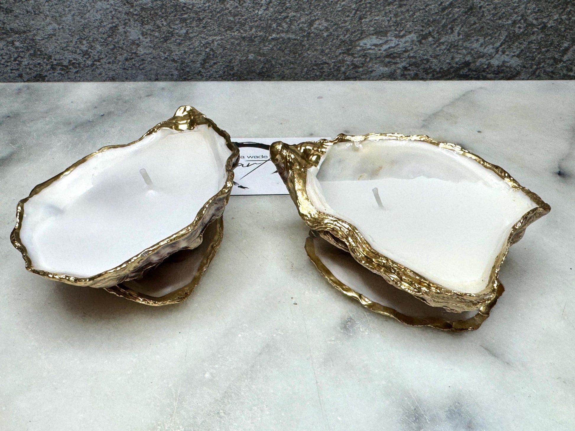 oyster shell candle, gold oyster candle, gilded oyster shells, hand poured candle, coastal decor, ocean inspired candle, beach home decor, sustainable candle, handmade in Surrey, luxury shell candle, sea lover gift, oyster shell pair, artisan candle, eco friendly candle, gold rim shell, nautical decor, ocean gift, coastal homeware, handmade oyster shell candle, shell wedding decor, seaside candle, mother of pearl shell, gold edged candle, beach cottage style, elegant coastal gift