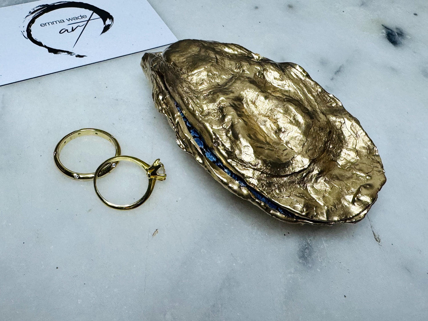 Dorset oyster shell ring box exterior showing gold leaf gilding and polished finish, photographed on a light background. Handcrafted coastal jewellery box with matching lid, highlighting the organic shell shape and gilded details, designed to hold engagement rings, wedding rings, or small jewellery pieces.