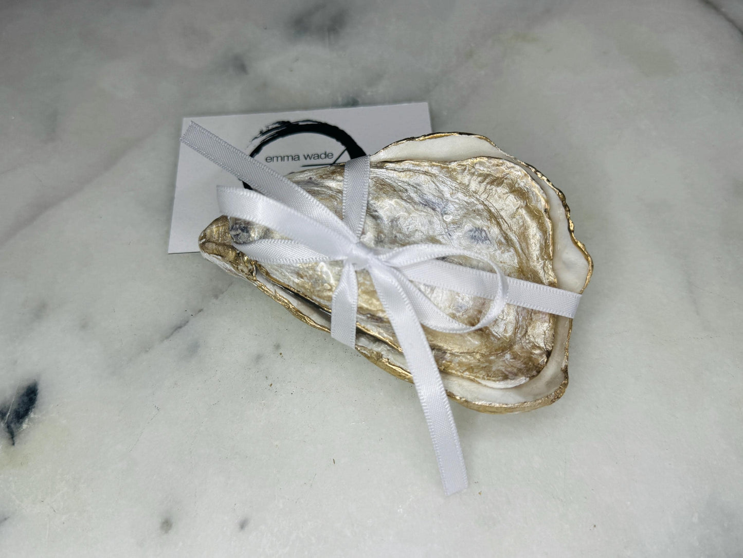 Dorset oyster shell ring box exterior showing natural shell texture with gold leaf edging and polished finish, photographed on a light background. Handcrafted coastal jewellery box with matching lid, highlighting the organic shell shape and gilded details, designed to hold engagement rings, wedding rings, or small jewellery pieces.