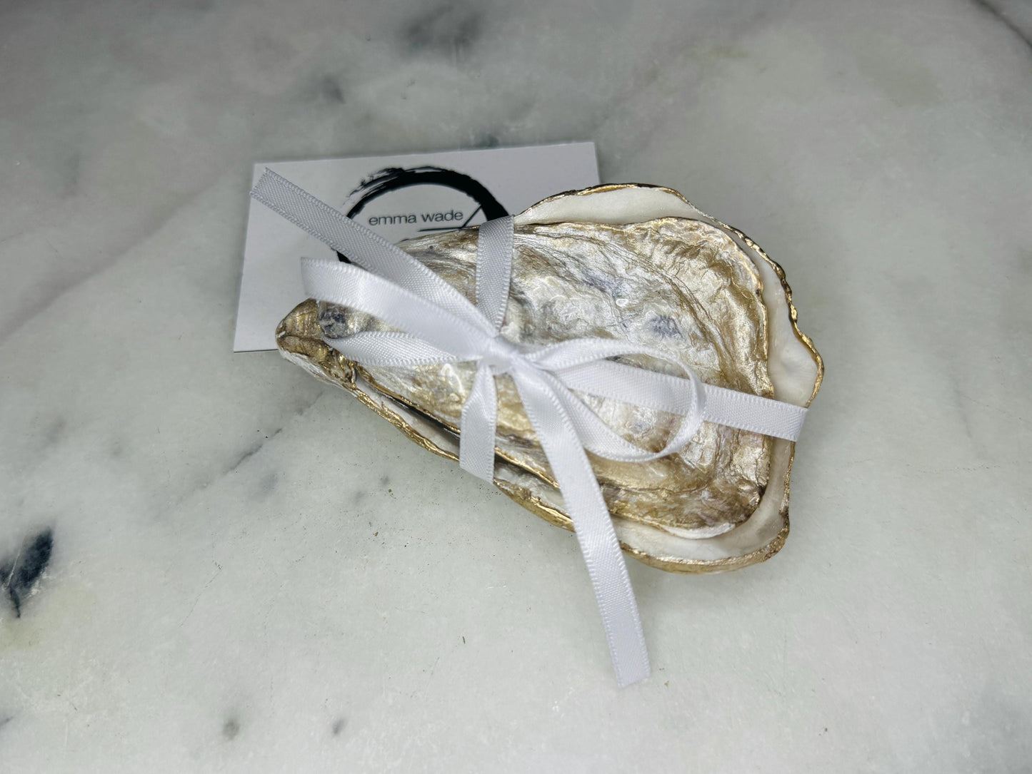 Dorset oyster shell ring box exterior showing natural shell texture with gold leaf edging and polished finish, photographed on a light background. Handcrafted coastal jewellery box with matching lid, highlighting the organic shell shape and gilded details, designed to hold engagement rings, wedding rings, or small jewellery pieces.