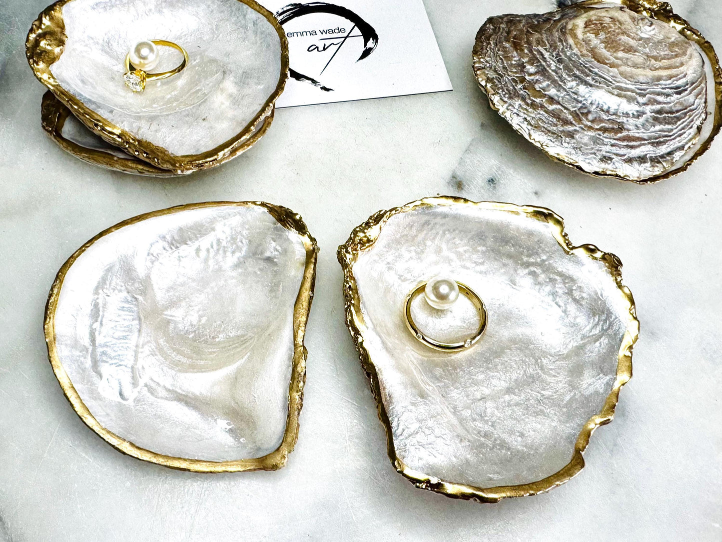 Luxury handmade saddle oyster shell ring box with soft pearlescent finish inside and out, gold leaf gilded rims and optional Swarovski pearl inset, unique coastal wedding ring bearer box, engagement proposal ring holder, decorative shell trinket dish displayed on light marble surface