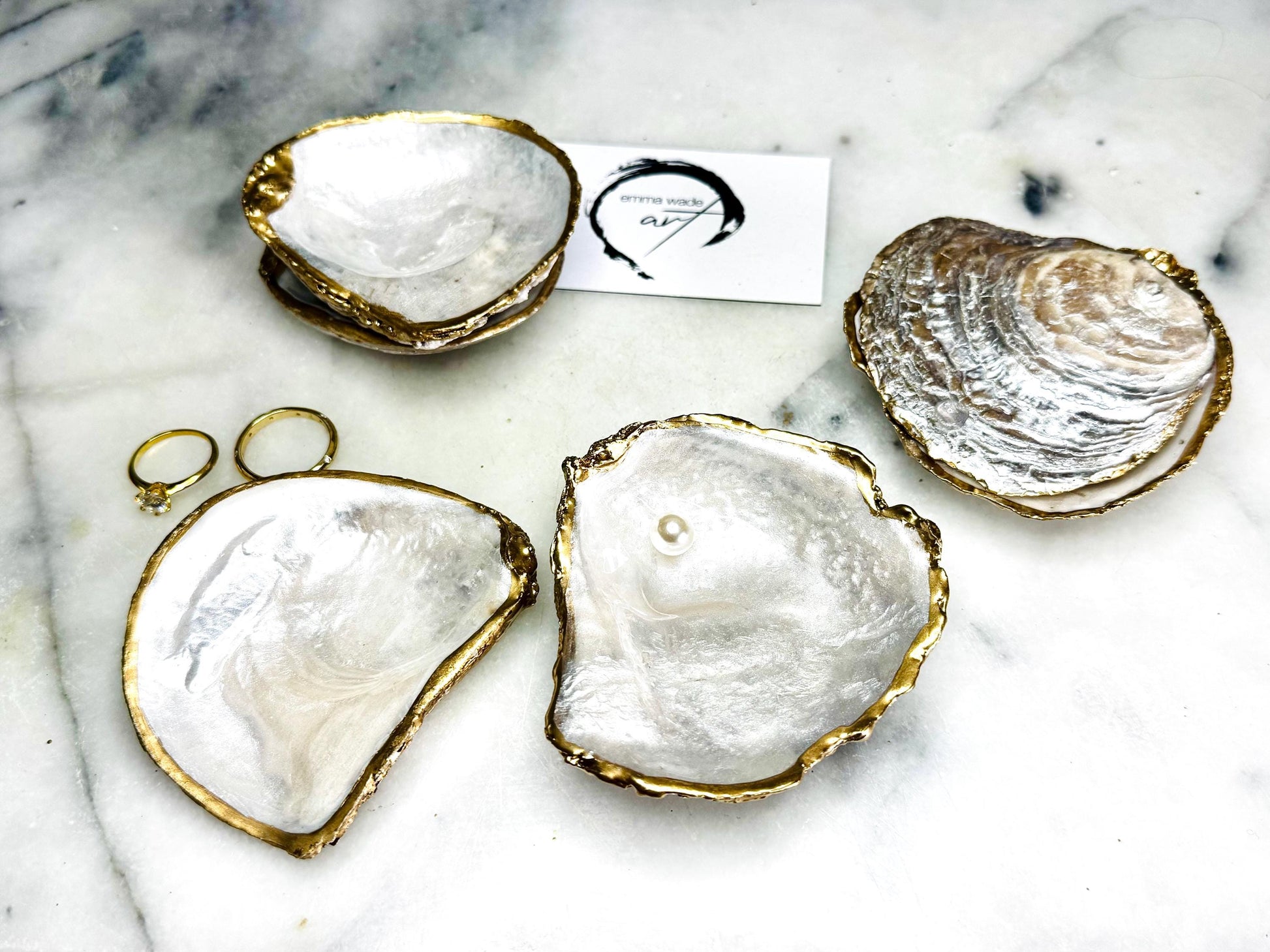 Luxury handmade saddle oyster shell ring box with soft pearlescent finish inside and out, gold leaf gilded rims and optional Swarovski pearl inset, unique coastal wedding ring bearer box, engagement proposal ring holder, decorative shell trinket dish displayed on light marble surface