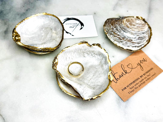Natural saddle oyster shell ring box handcrafted with pearlised interior and exterior, sealed with high gloss resin and edged in liquid gold leaf, optional Swarovski pearl ring holder, elegant coastal wedding ring bearer box or proposal ring dish styled on neutral background