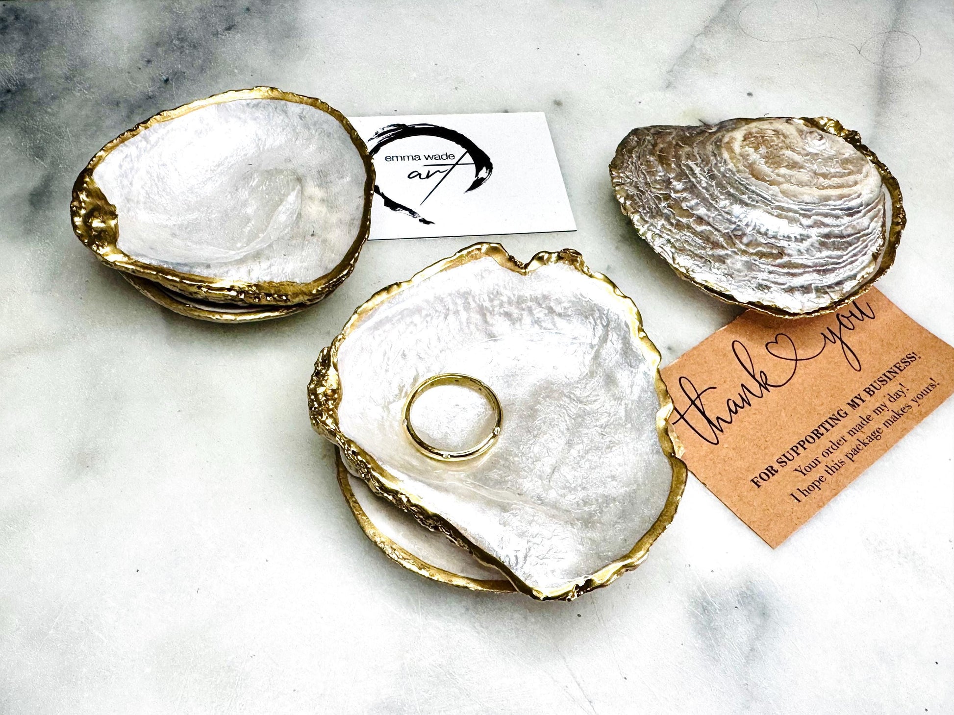Handcrafted saddle oyster shell ring box with pearlescent finish inside and outside, gold leaf gilded edges and optional Swarovski pearl inset, coastal wedding ring bearer box, engagement proposal ring holder, luxury shell jewellery dish, unique handmade UK gift on marble backdrop