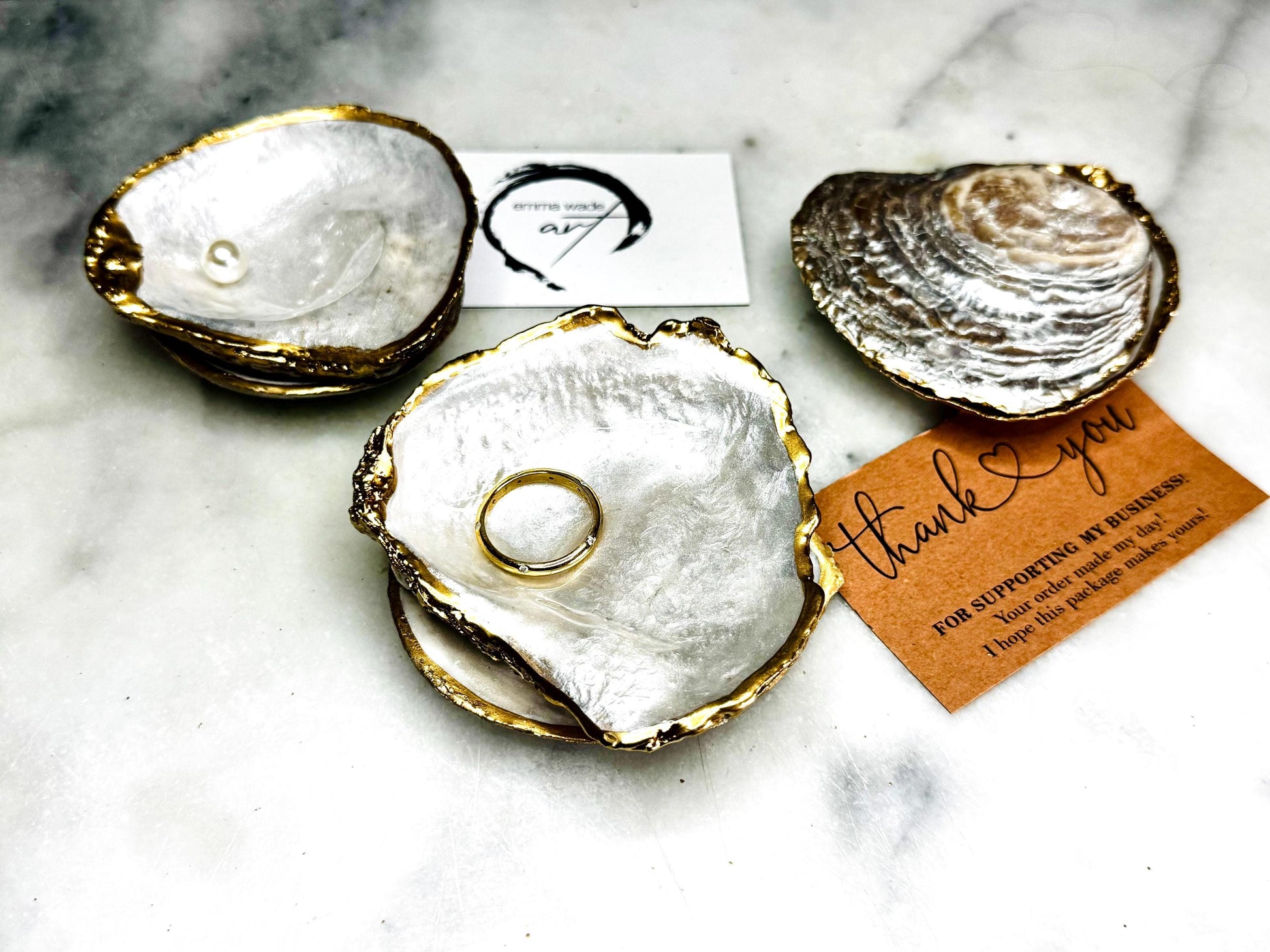 Handcrafted saddle oyster shell ring box with pearlescent finish inside and outside, gold leaf gilded edges and optional Swarovski pearl inset, coastal wedding ring bearer box, engagement proposal ring holder, luxury shell jewellery dish, unique handmade UK gift on marble backdrop
