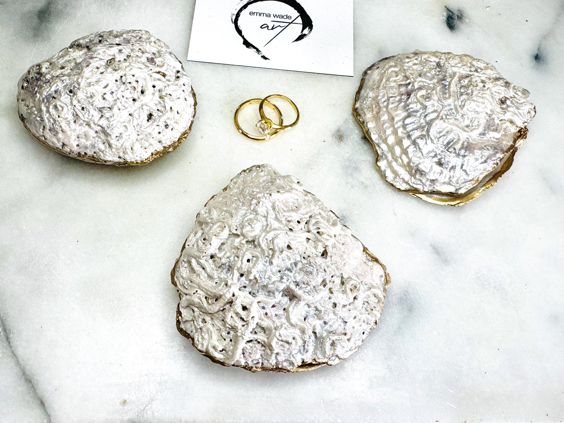 Handmade saddle oyster shell ring box with pearlescent interior and pearlised exterior, finished with gold leaf gilded edges and optional Swarovski pearl ring holder, luxury coastal wedding ring bearer box, proposal ring presentation dish, artisan shell jewellery holder styled on neutral marble background