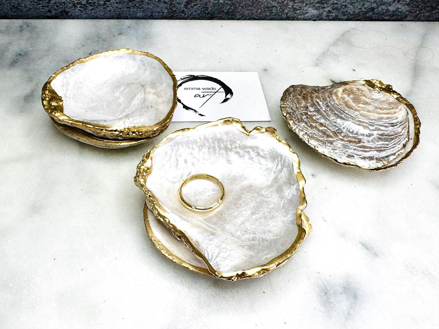 Luxury handmade saddle oyster shell ring box with soft pearlescent finish inside and out, gold leaf gilded rims and optional Swarovski pearl inset, unique coastal wedding ring bearer box, engagement proposal ring holder, decorative shell trinket dish displayed on light marble surface