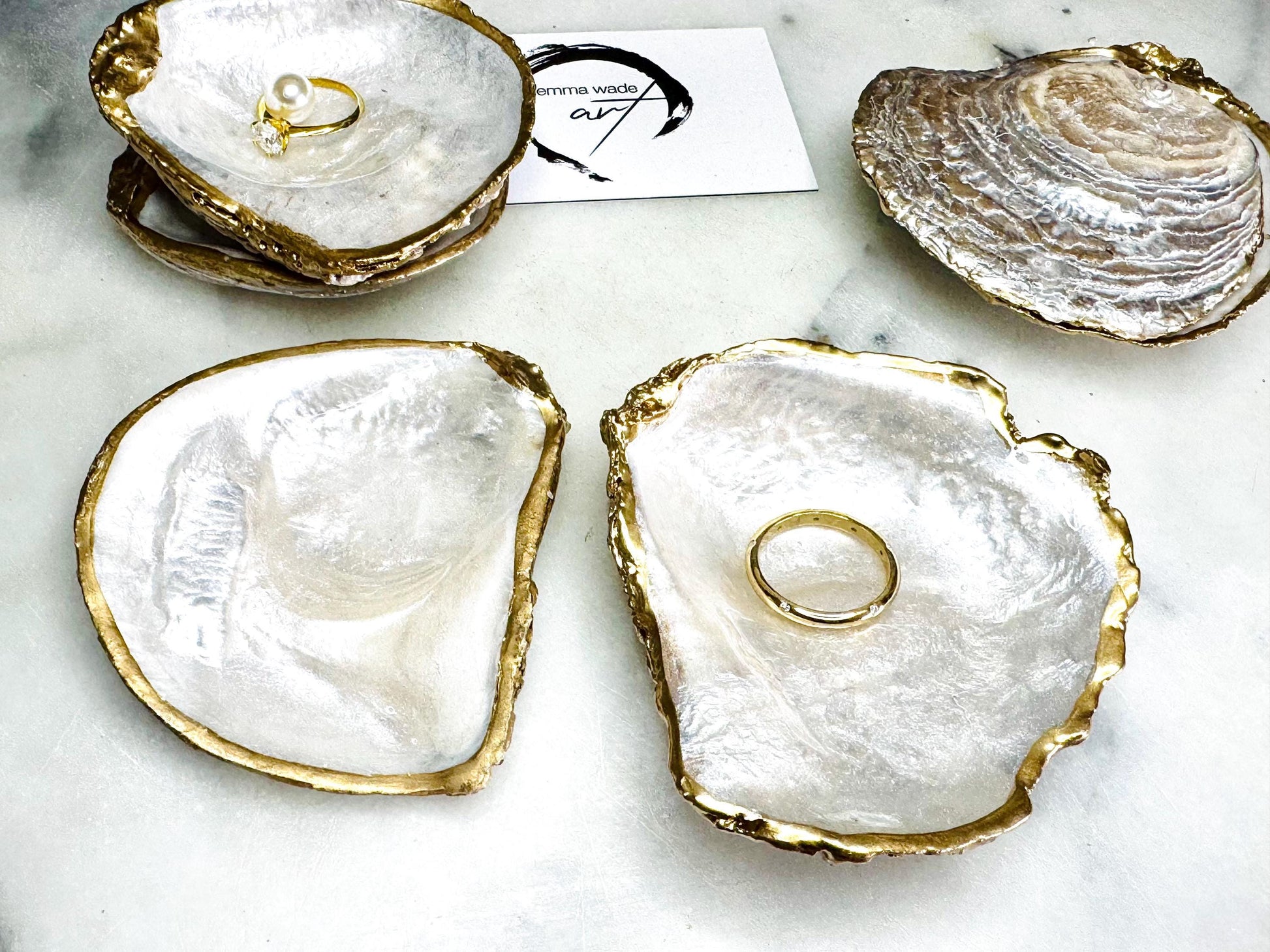 Luxury handmade saddle oyster shell ring box with soft pearlescent finish inside and out, gold leaf gilded rims and optional Swarovski pearl inset, unique coastal wedding ring bearer box, engagement proposal ring holder, decorative shell trinket dish displayed on light marble surface