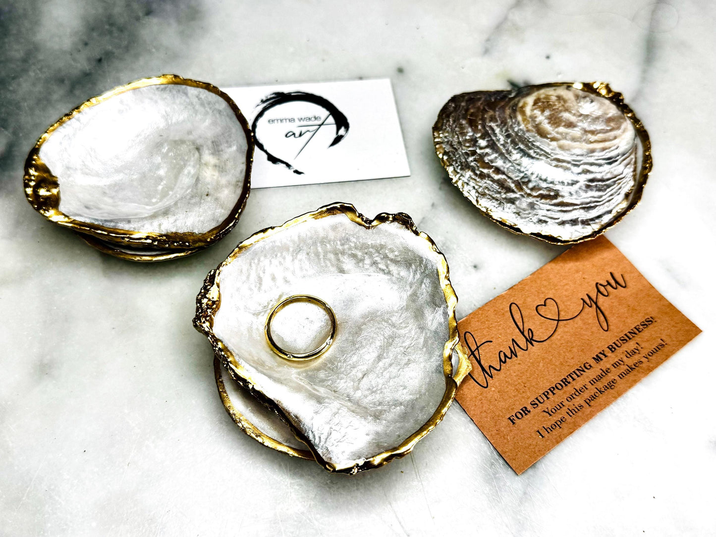 Natural saddle oyster shell ring box handcrafted with pearlised interior and exterior, sealed with high gloss resin and edged in liquid gold leaf, optional Swarovski pearl ring holder, elegant coastal wedding ring bearer box or proposal ring dish styled on neutral background